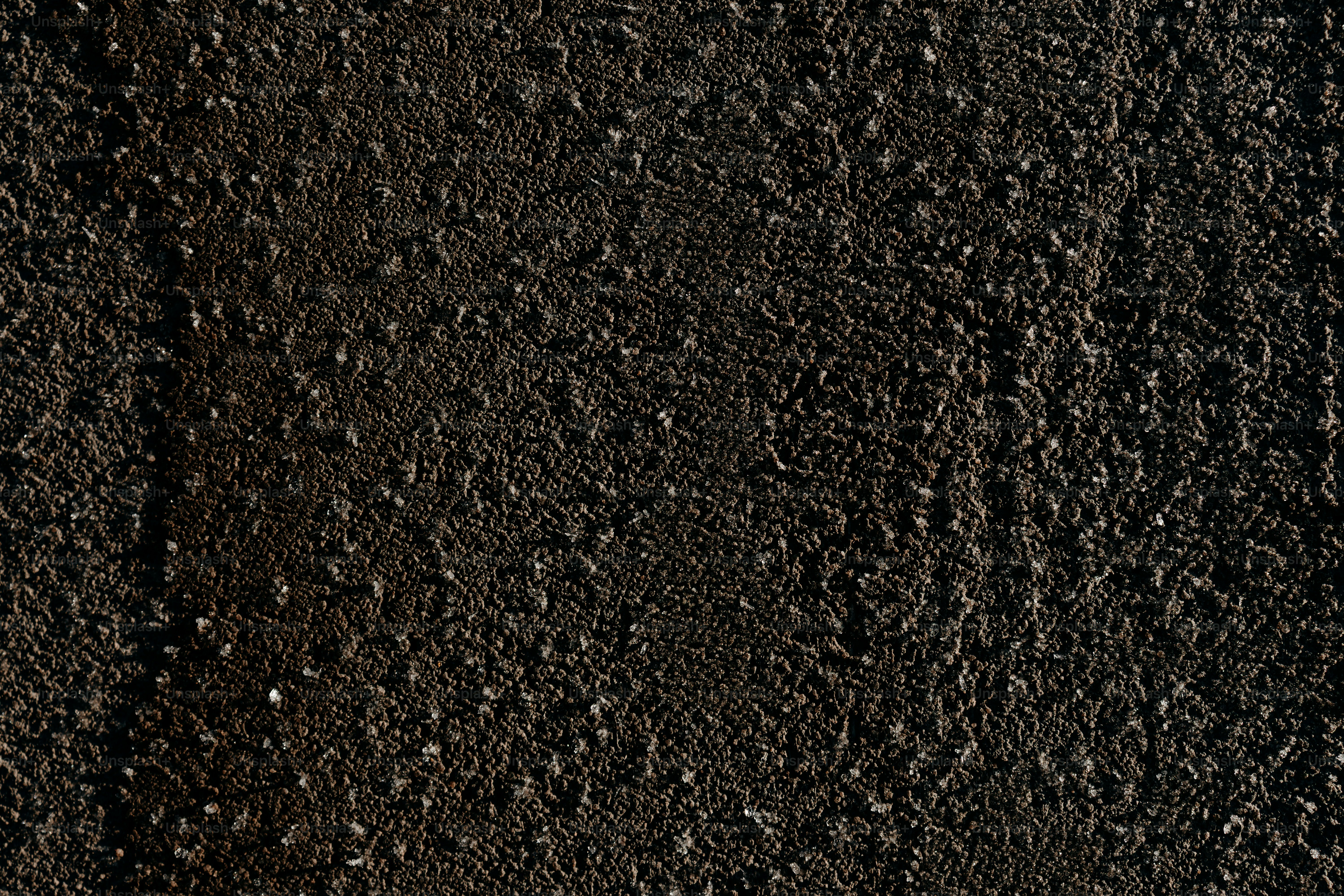 Dark textured surface with small pebbles