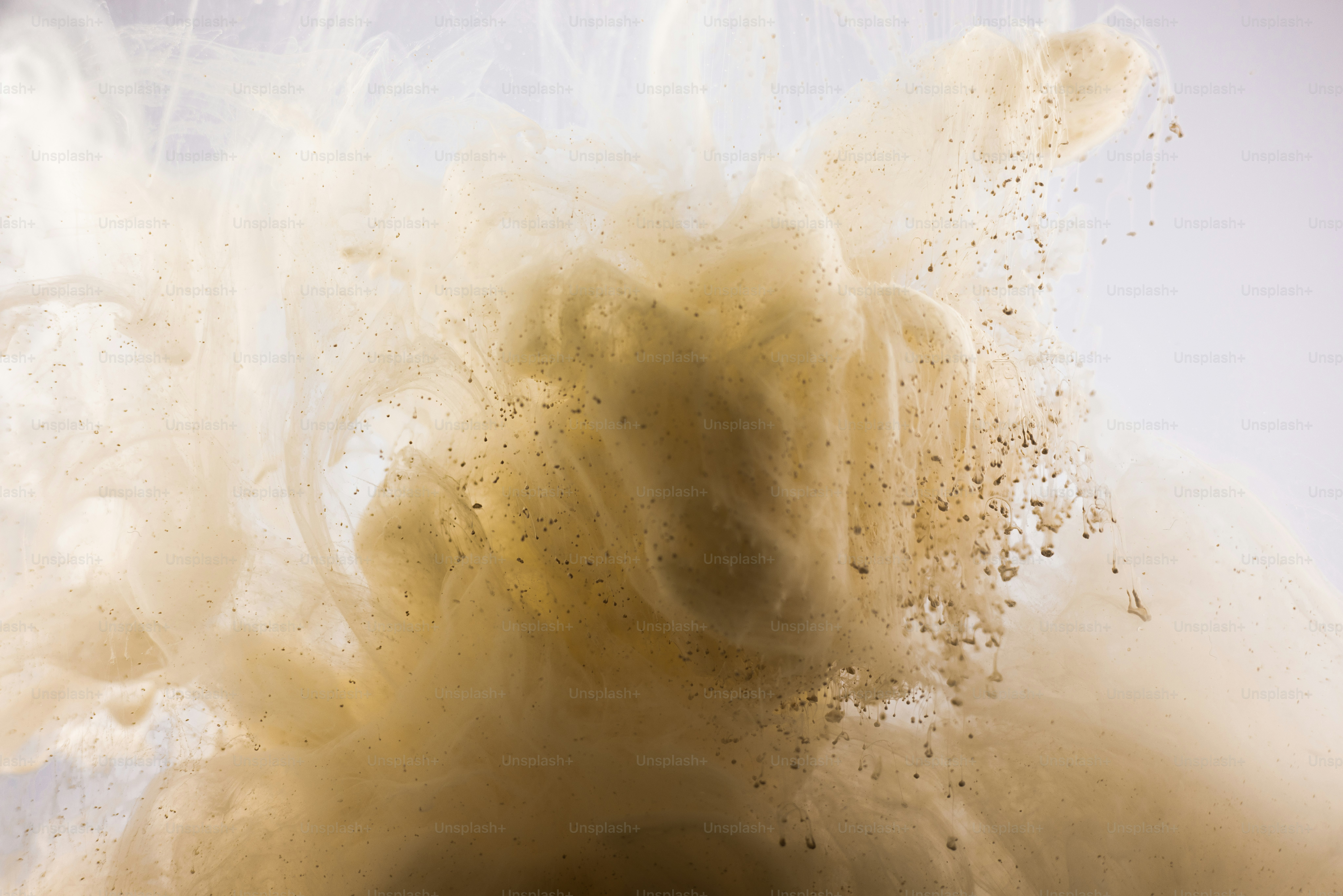 Abstract swirls of light brown ink in water