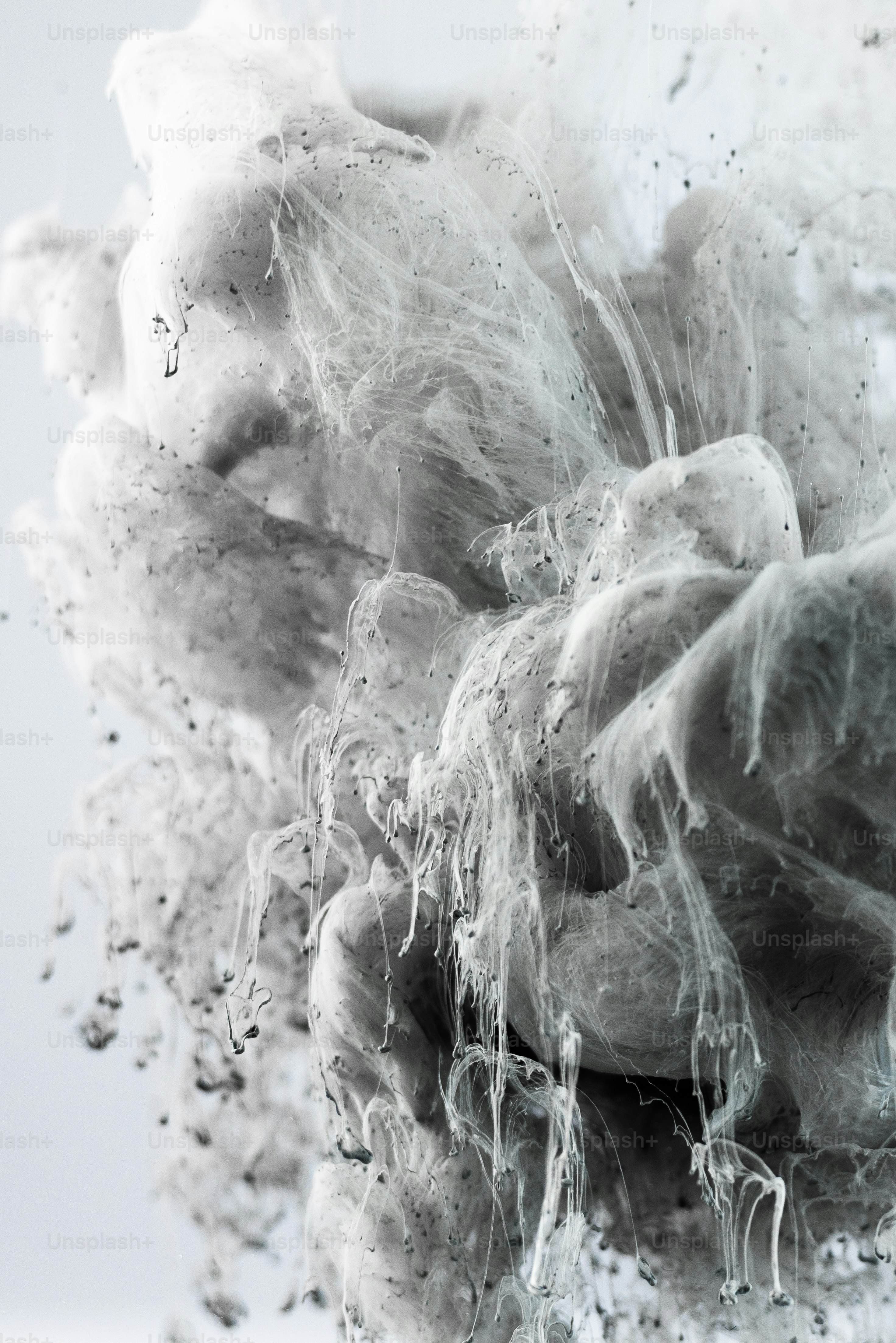 Abstract white and gray smoke or ink swirling.