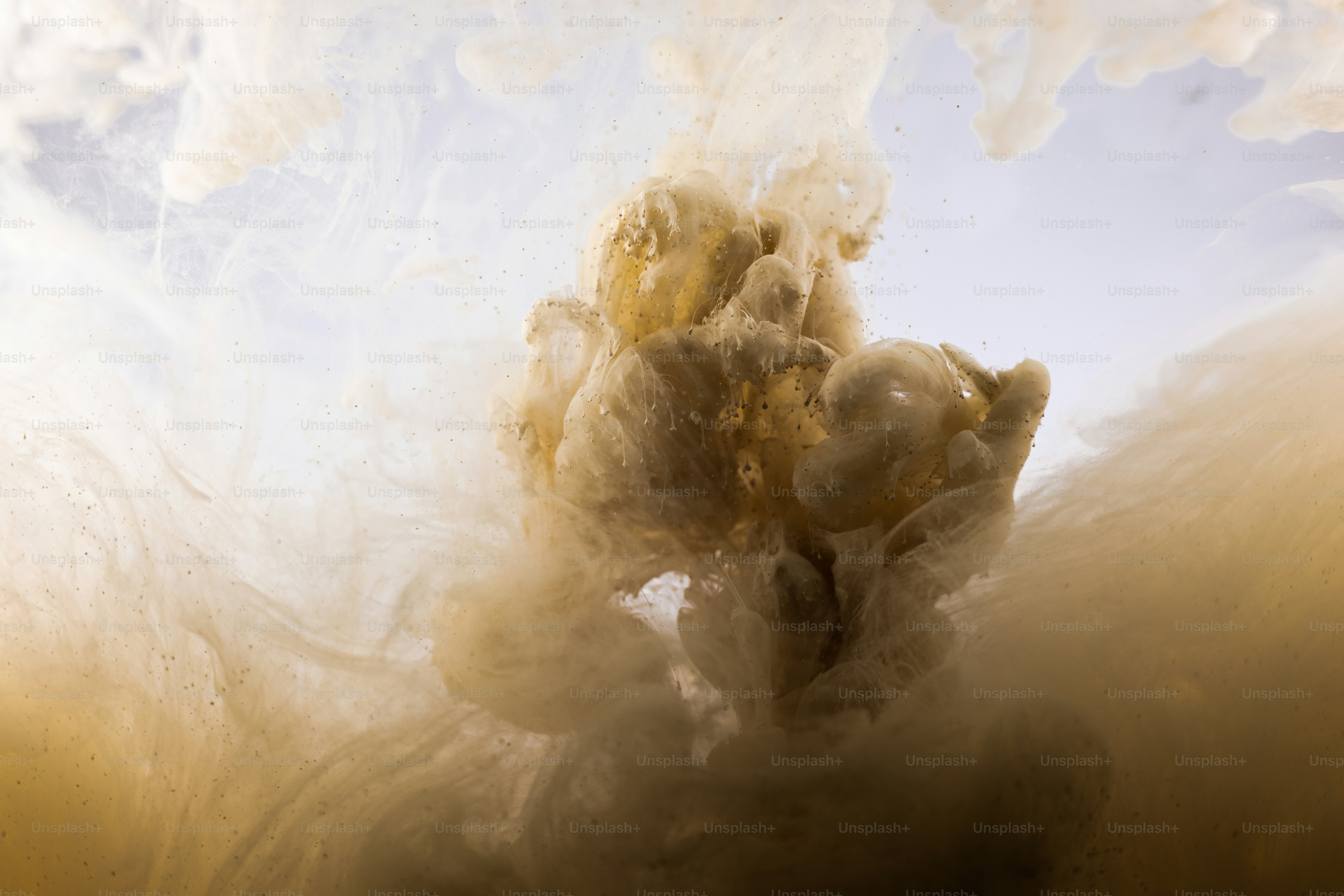 Brown and white ink swirling in water