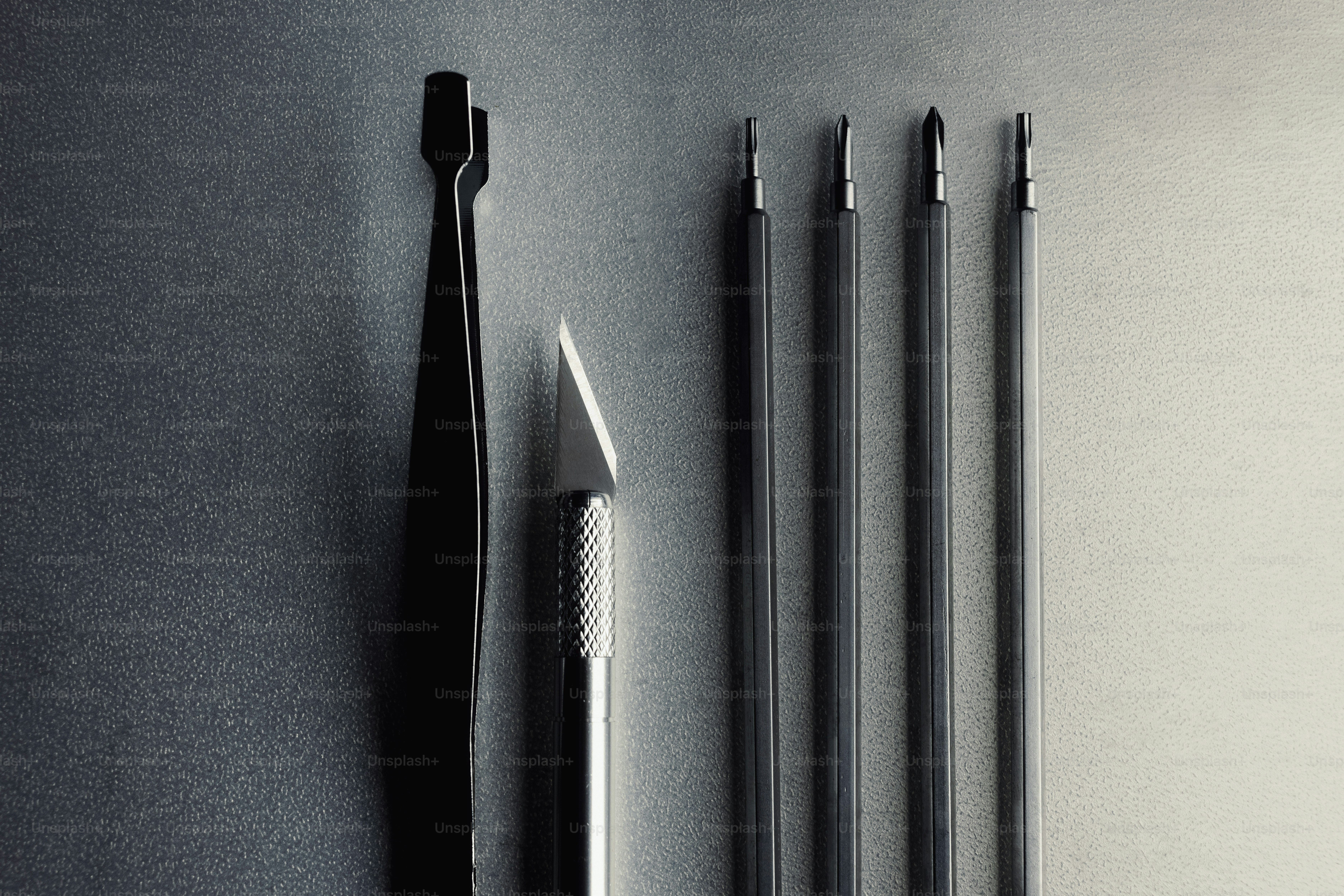 Surgical instruments including tweezers and scalpels arranged neatly.