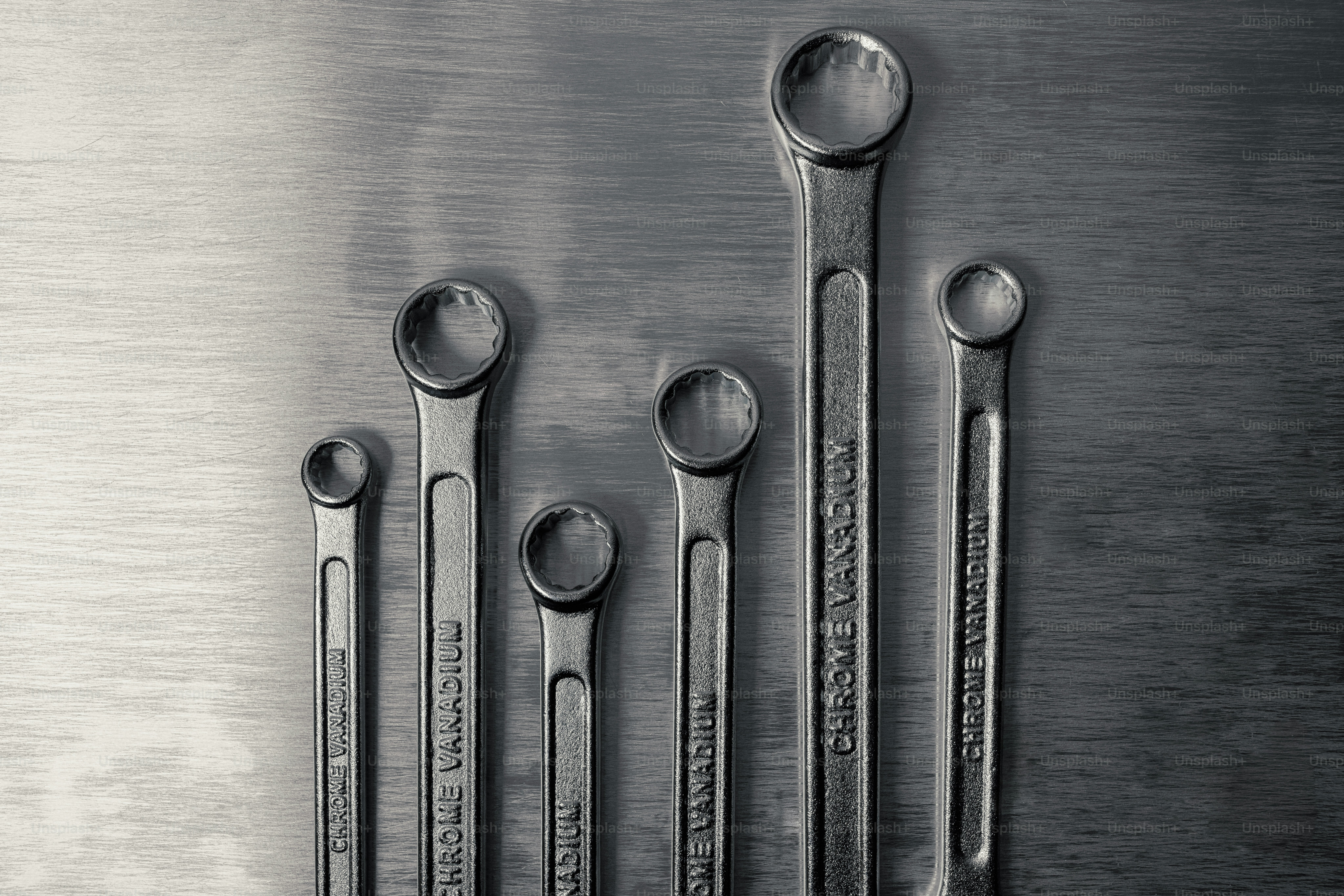 A group of wrenches on a metallic surface