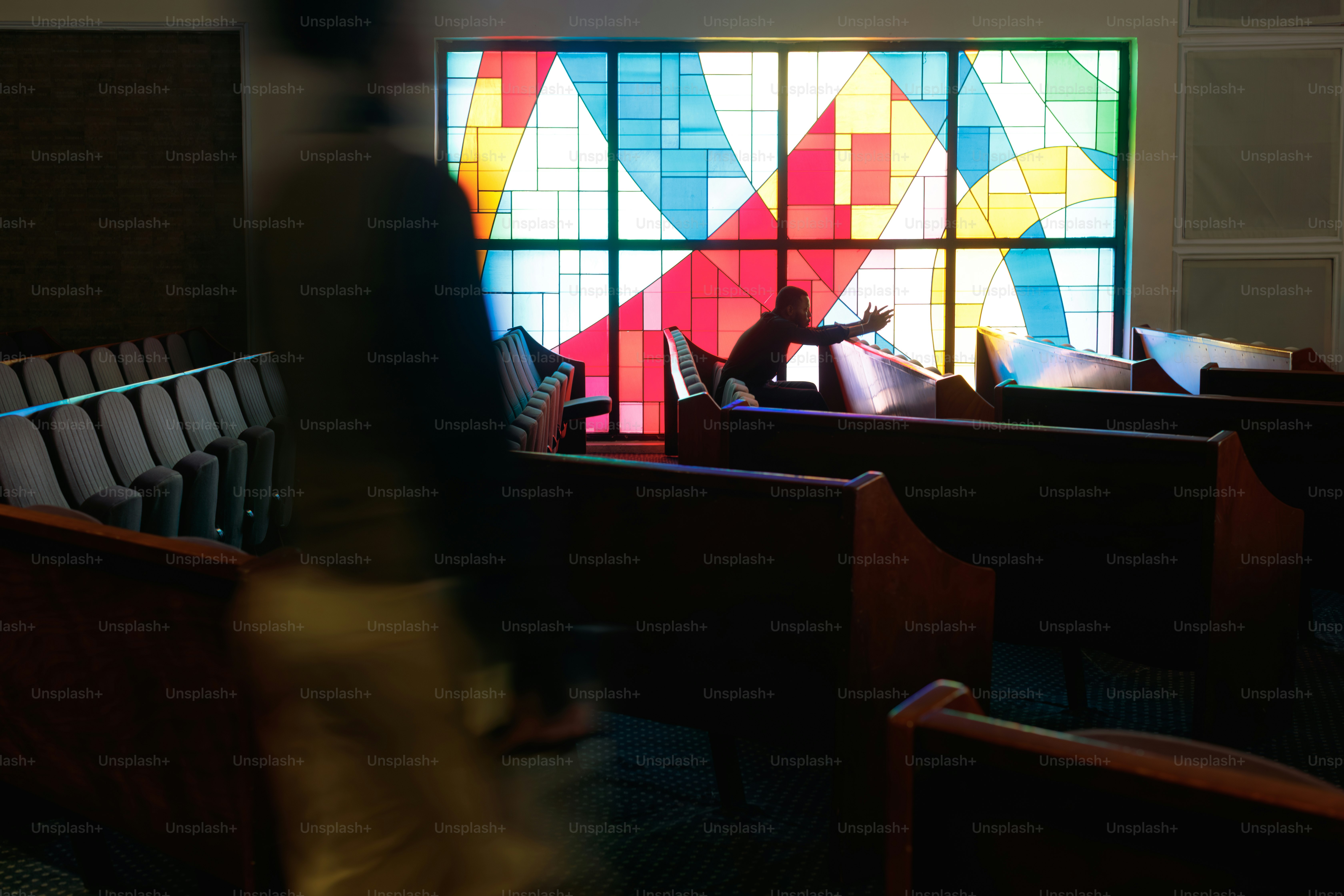 Colorful stained glass window in a church sanctuary.