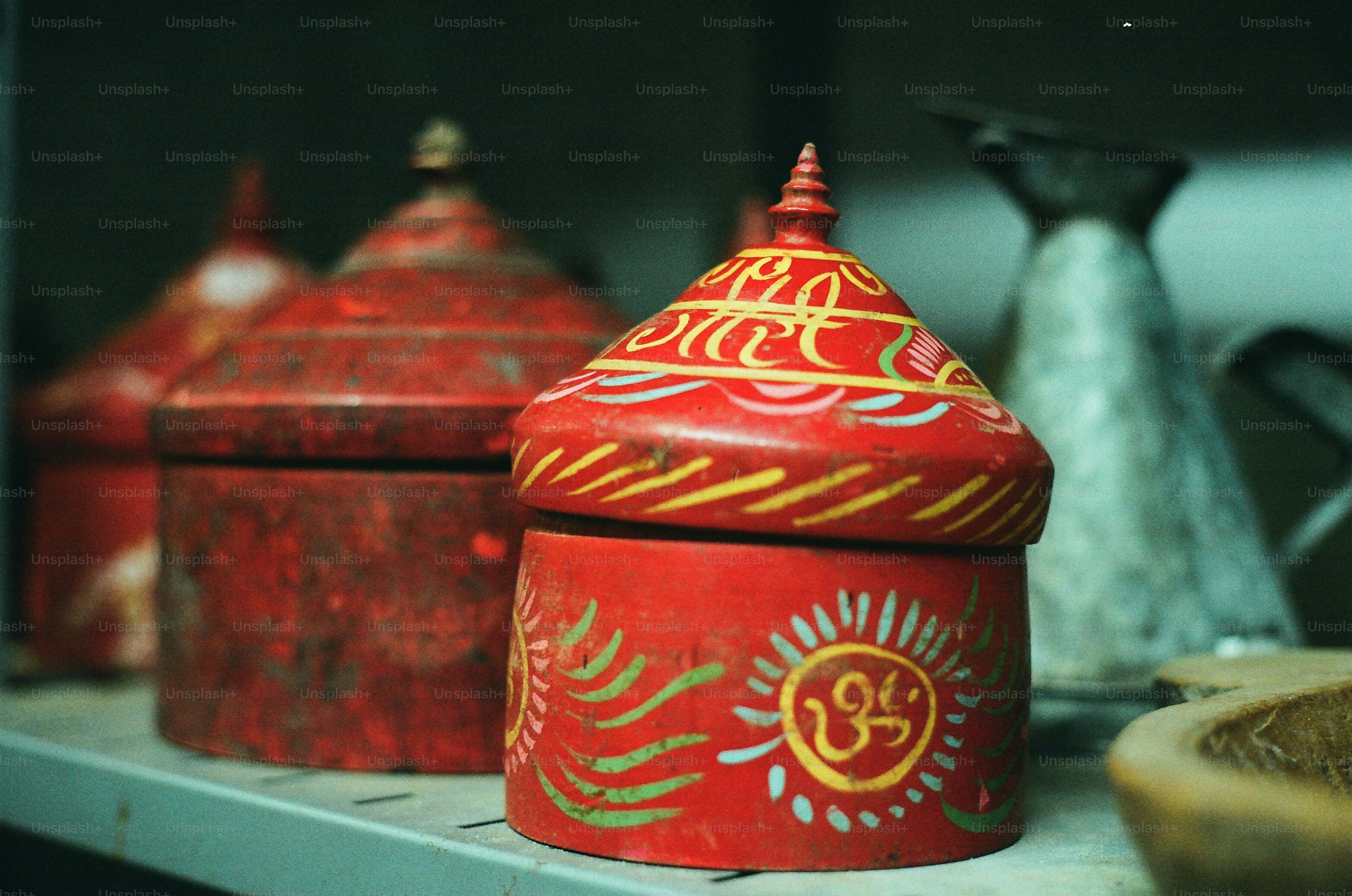 Red decorative boxes with intricate yellow designs