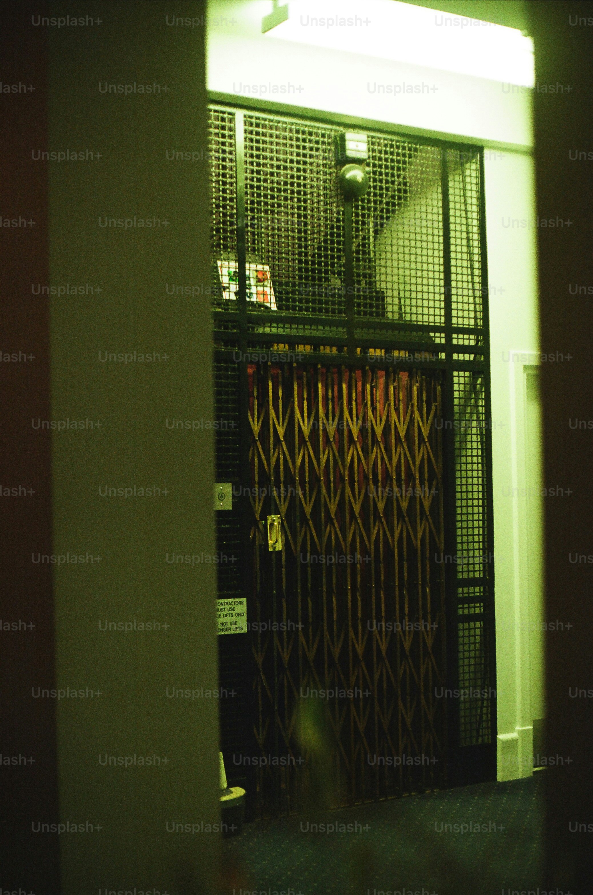 An old-fashioned elevator with a metal gate.