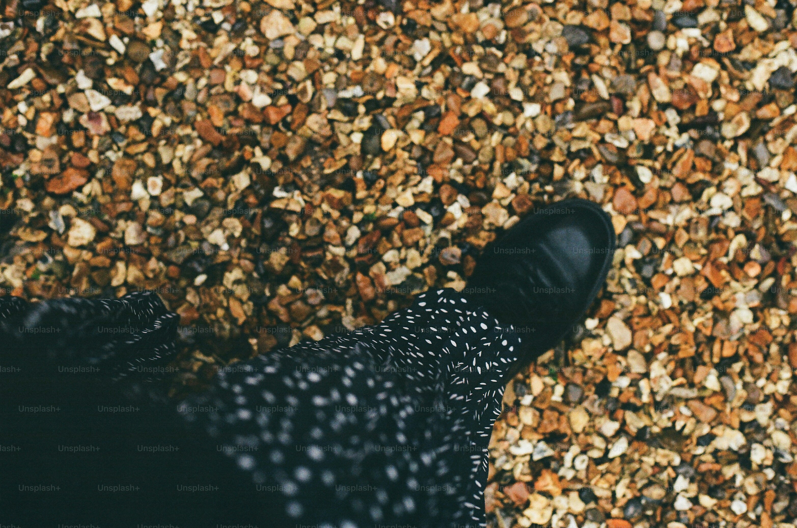 A black shoe on a gravel path