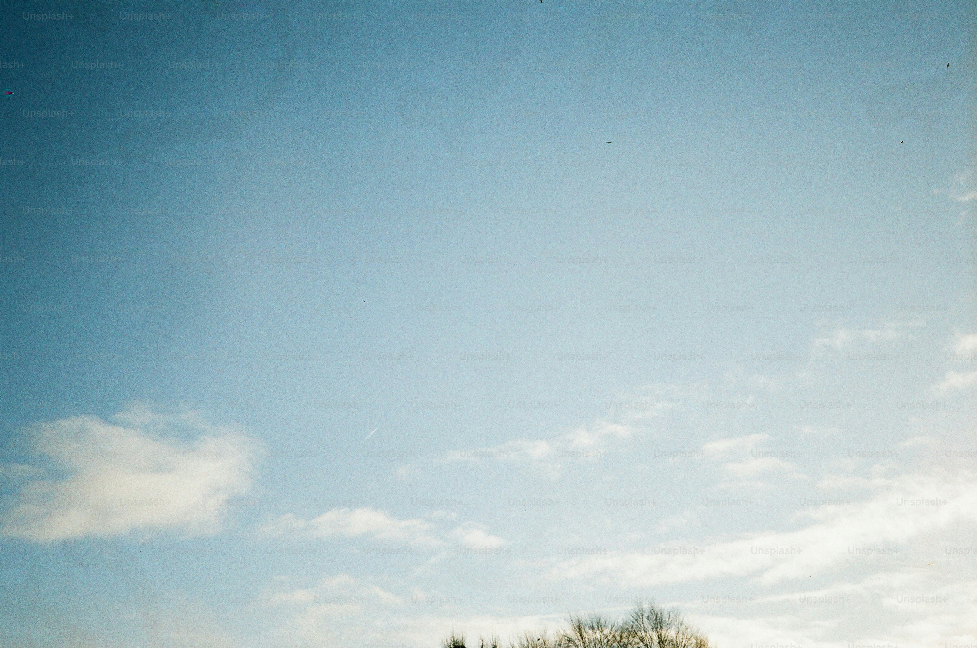 Clear blue sky with scattered white clouds