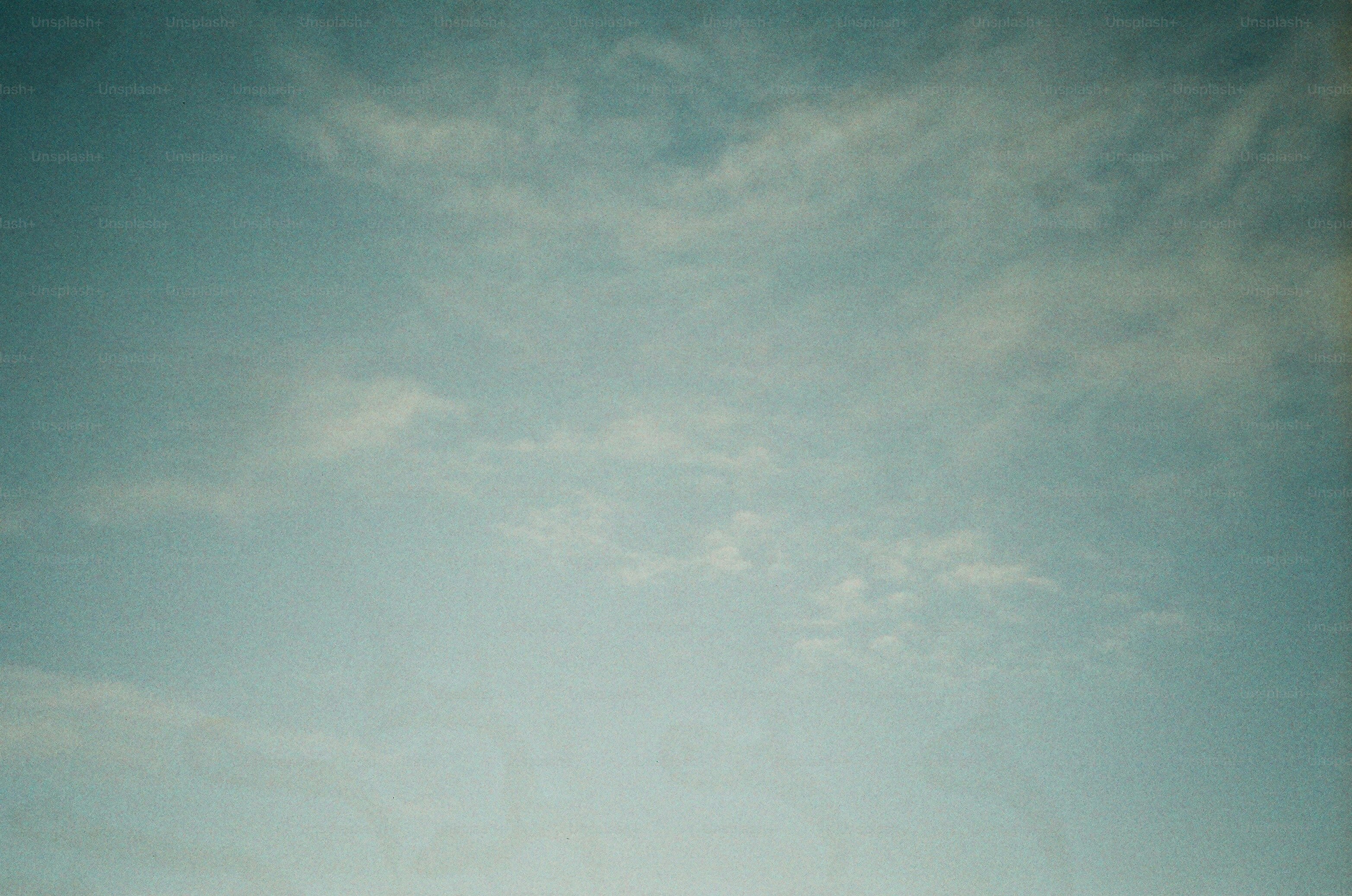 Wispy clouds drift across a pale blue sky.