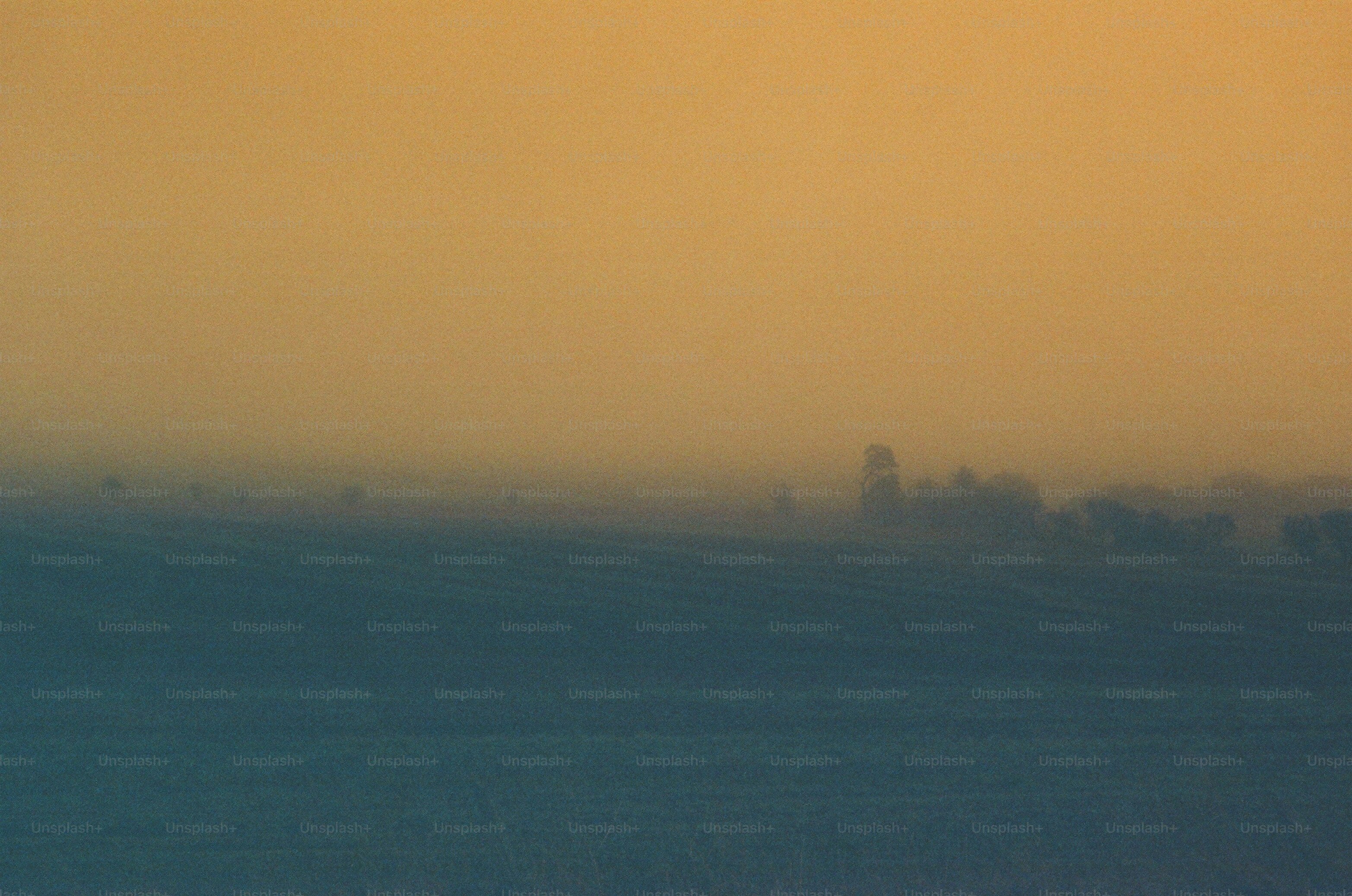 Misty landscape with distant buildings at sunrise