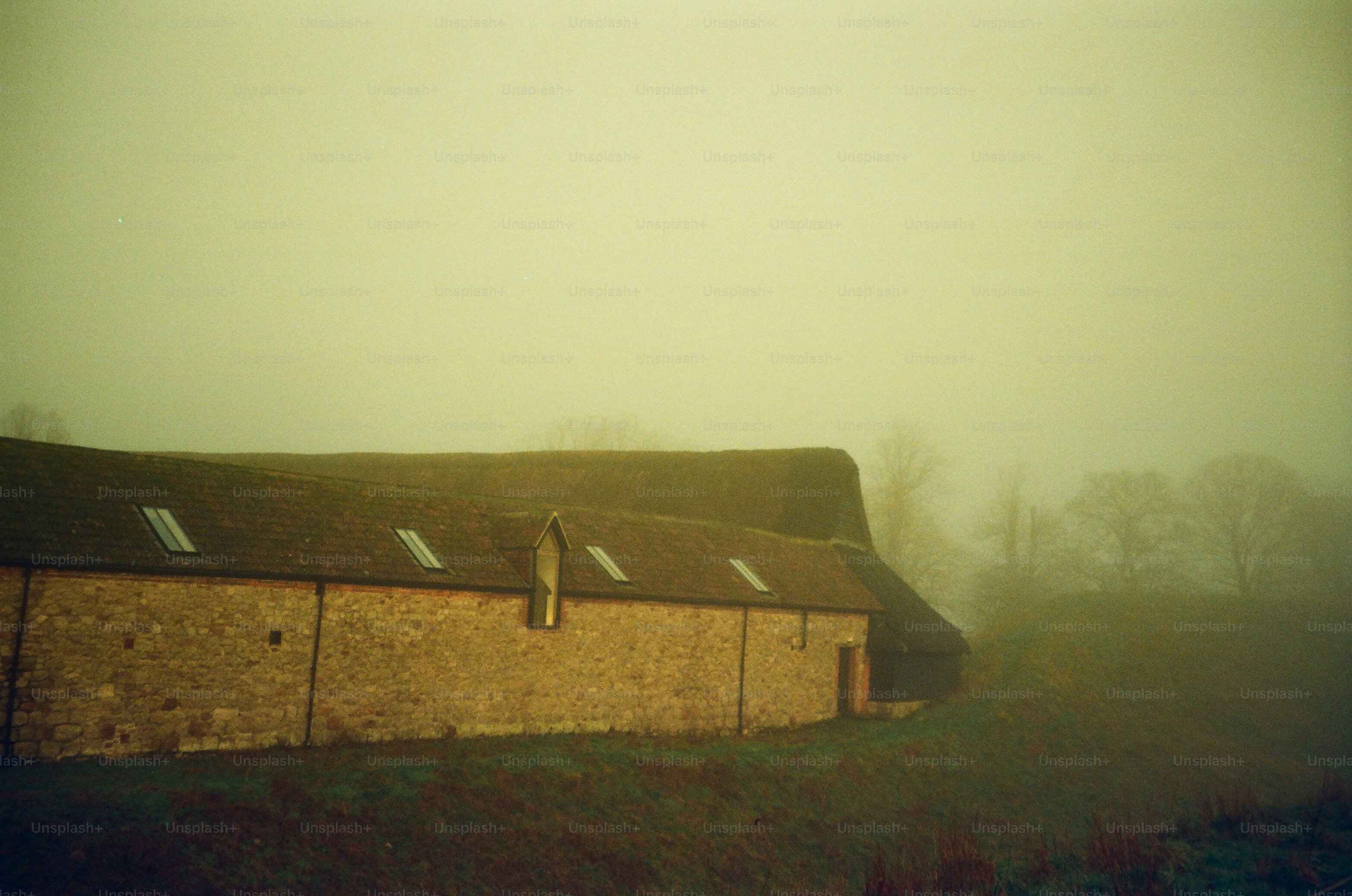 Old stone barn in foggy countryside