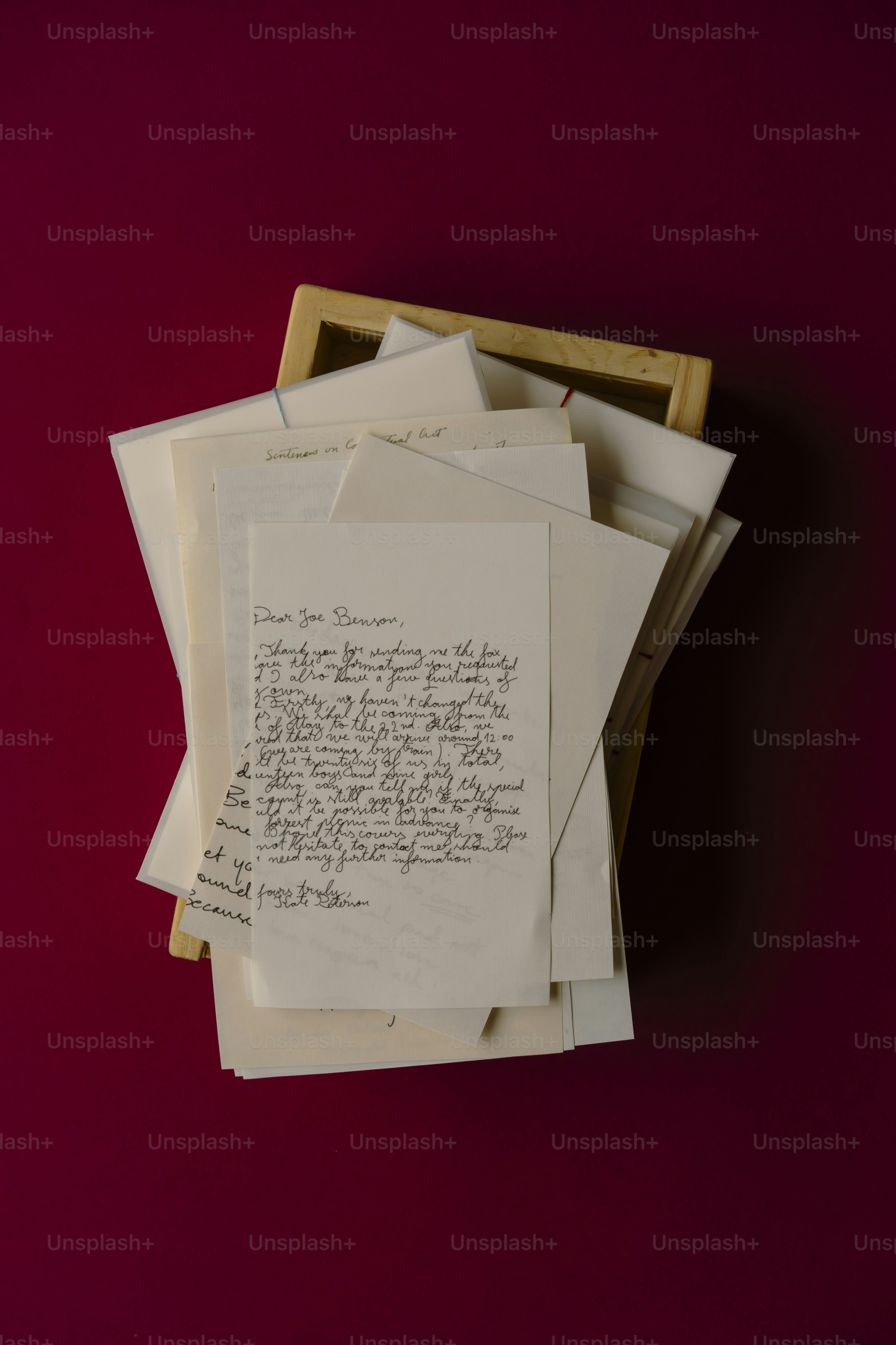 Stack of old letters in a wooden box