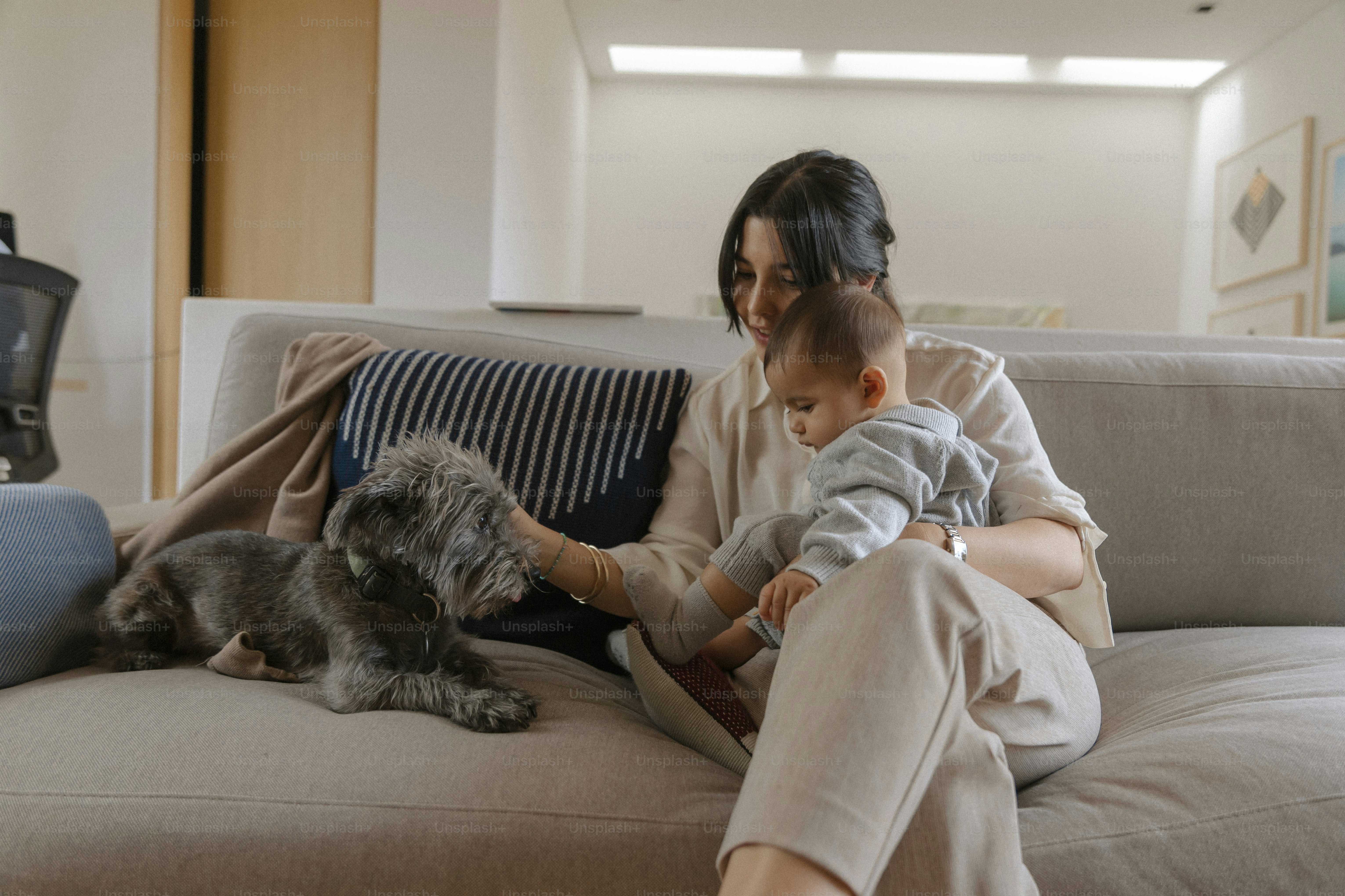 Woman with baby and dog on a couch