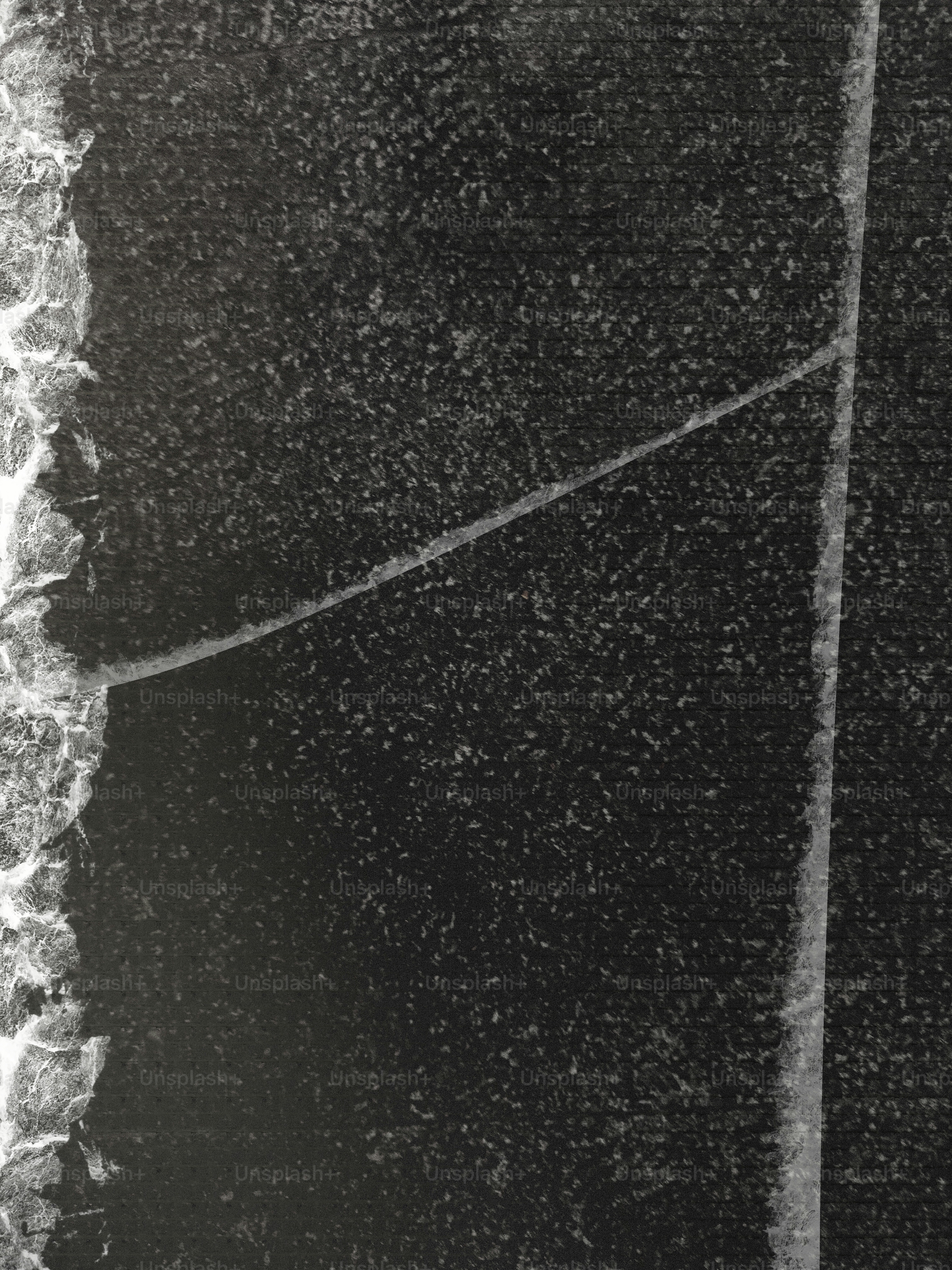 Rissige dunkle Oberfläche mit einer leichten Linie