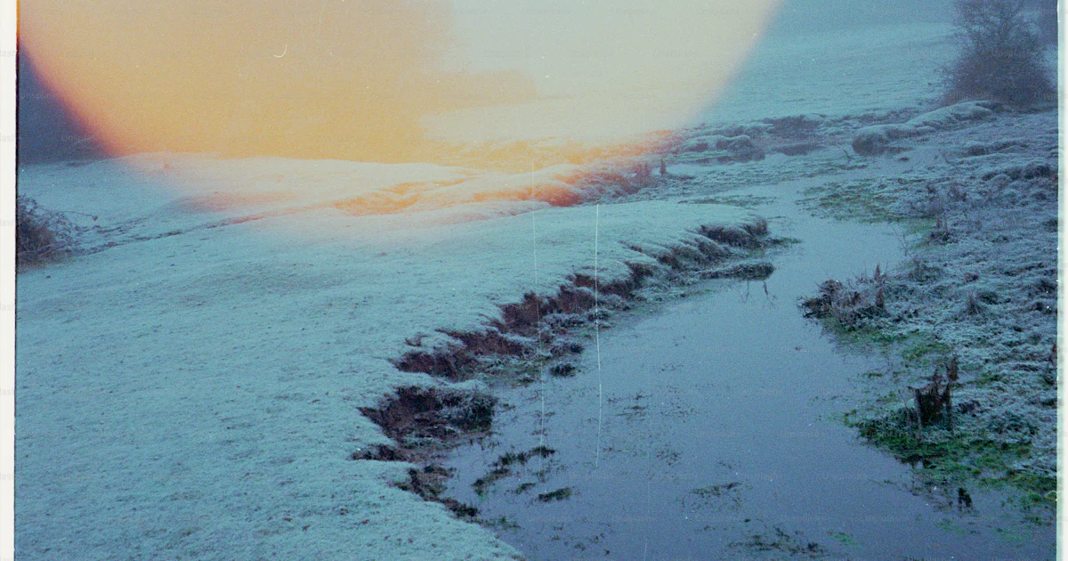 A frosty landscape with a winding stream and large orb. photo – Winter ...