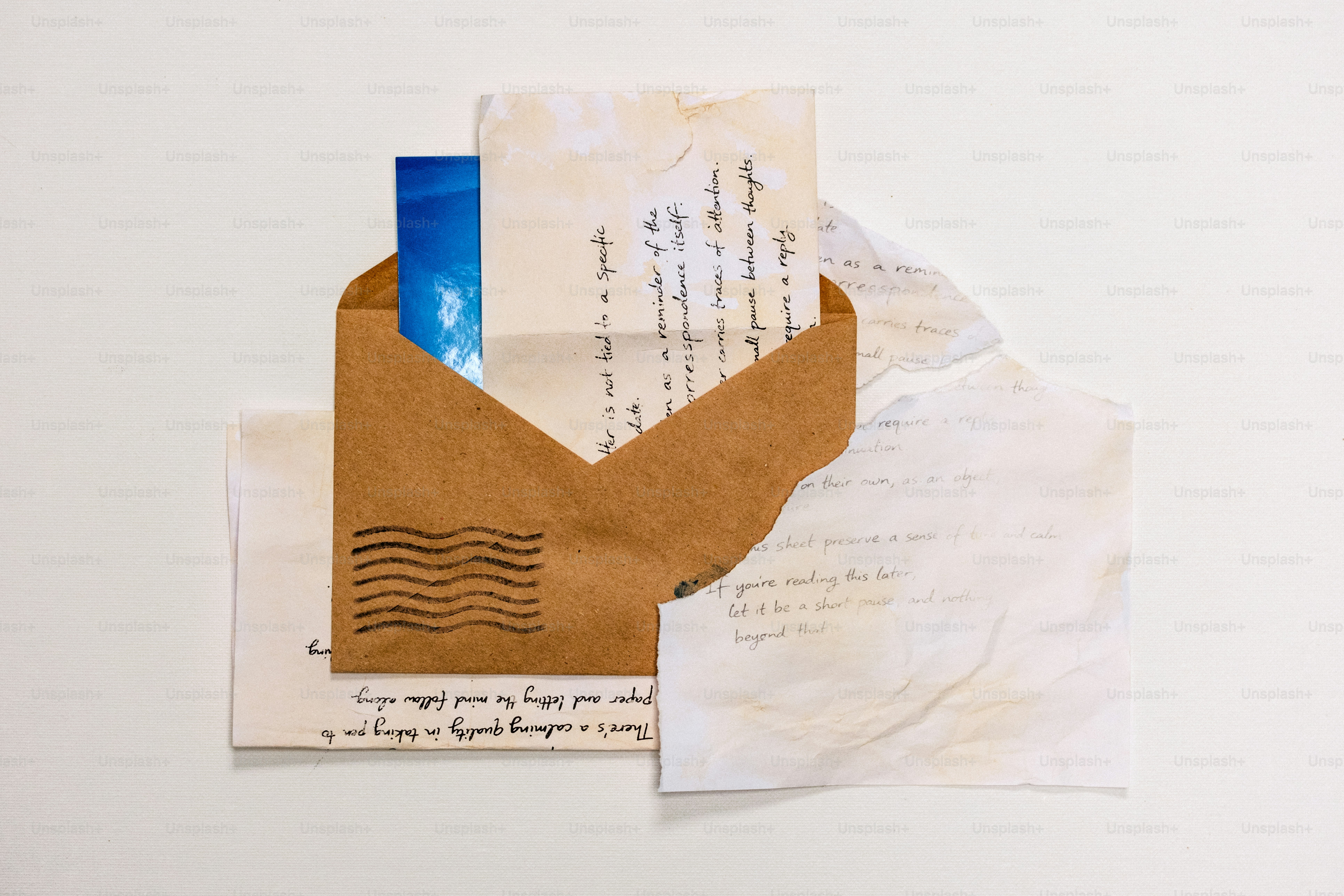 An open envelope with letters and a blue sky image. photo – Paper Image ...