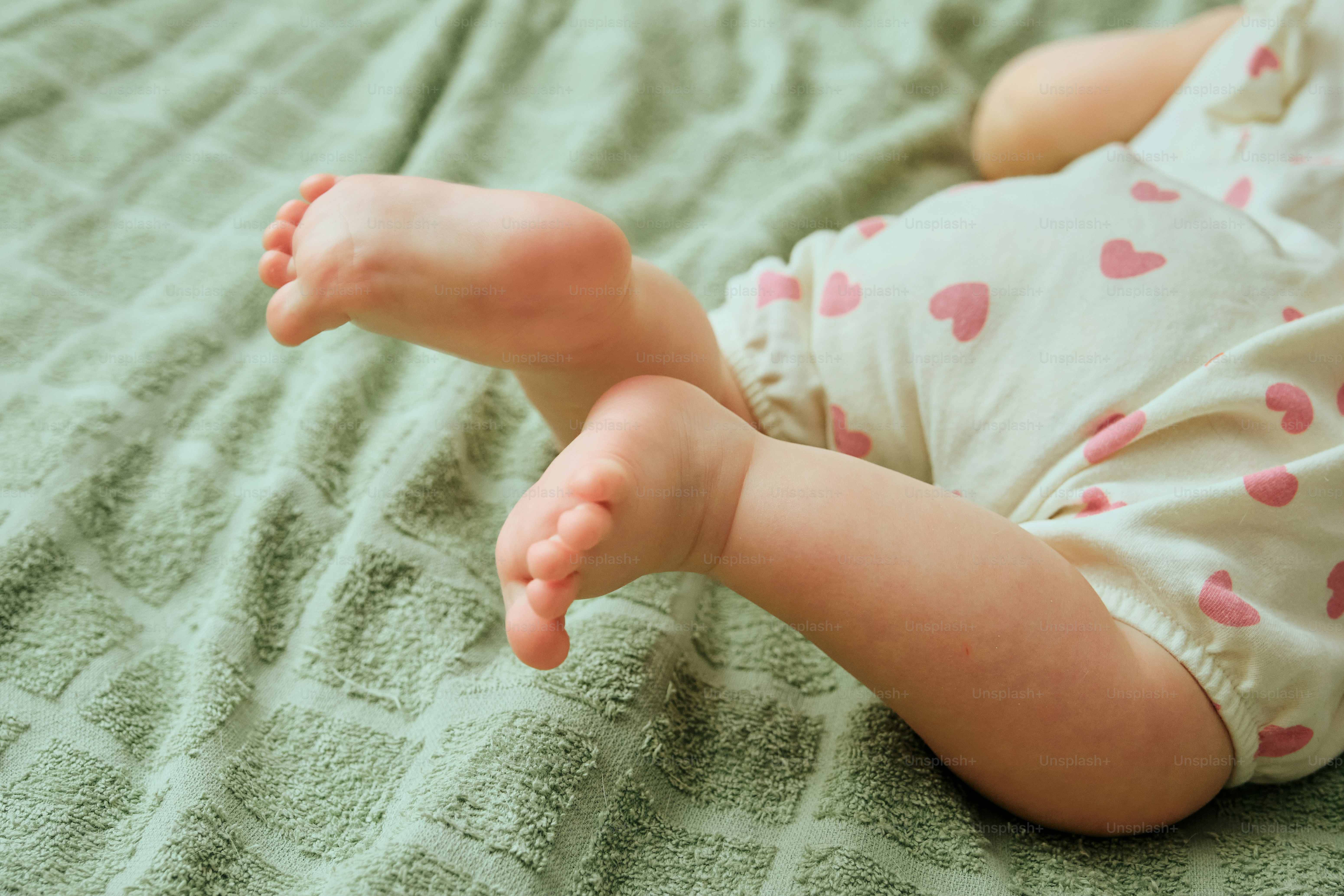 Close-up of a baby's feet and legs on a blanket