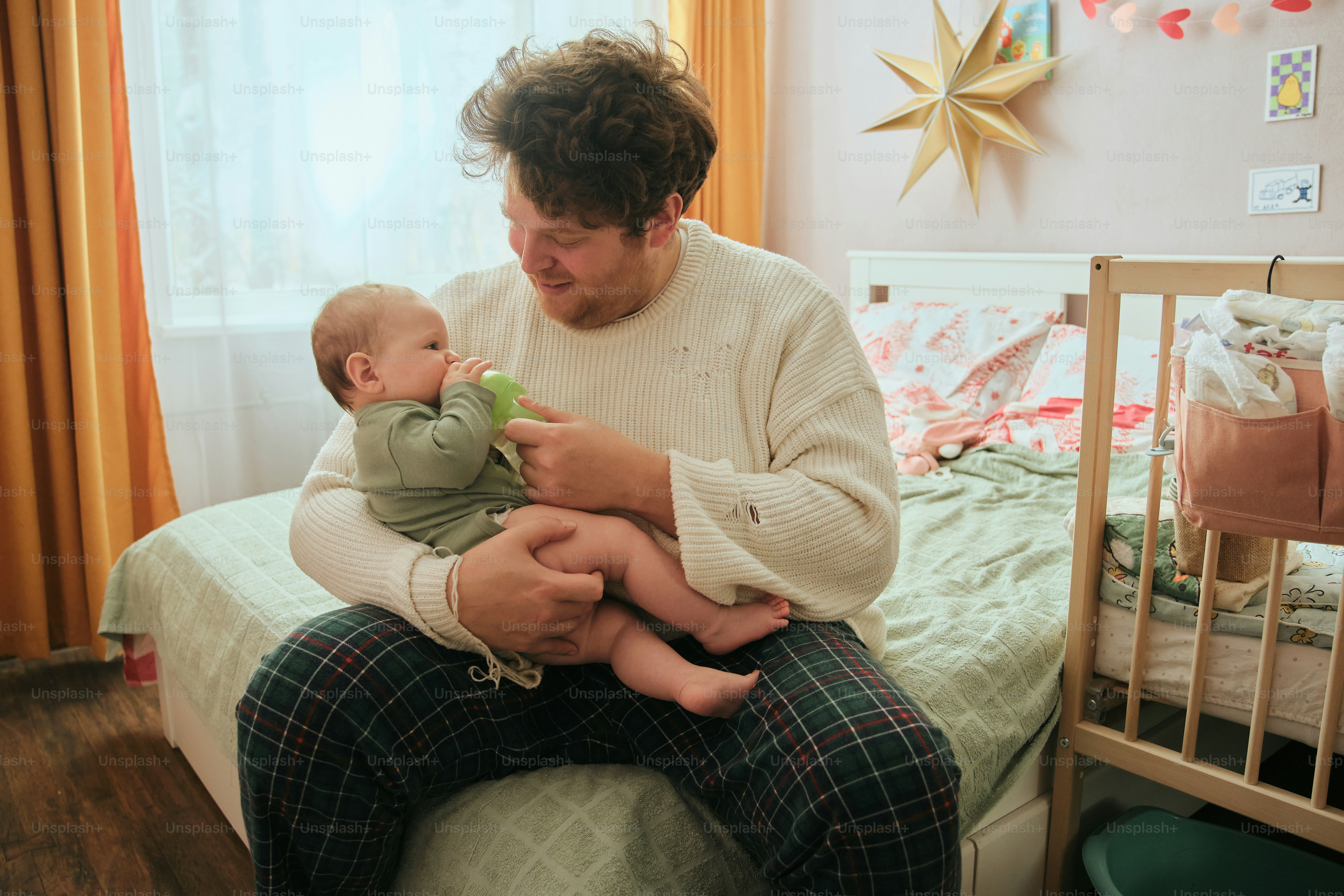 Man feeding a baby from a bottle