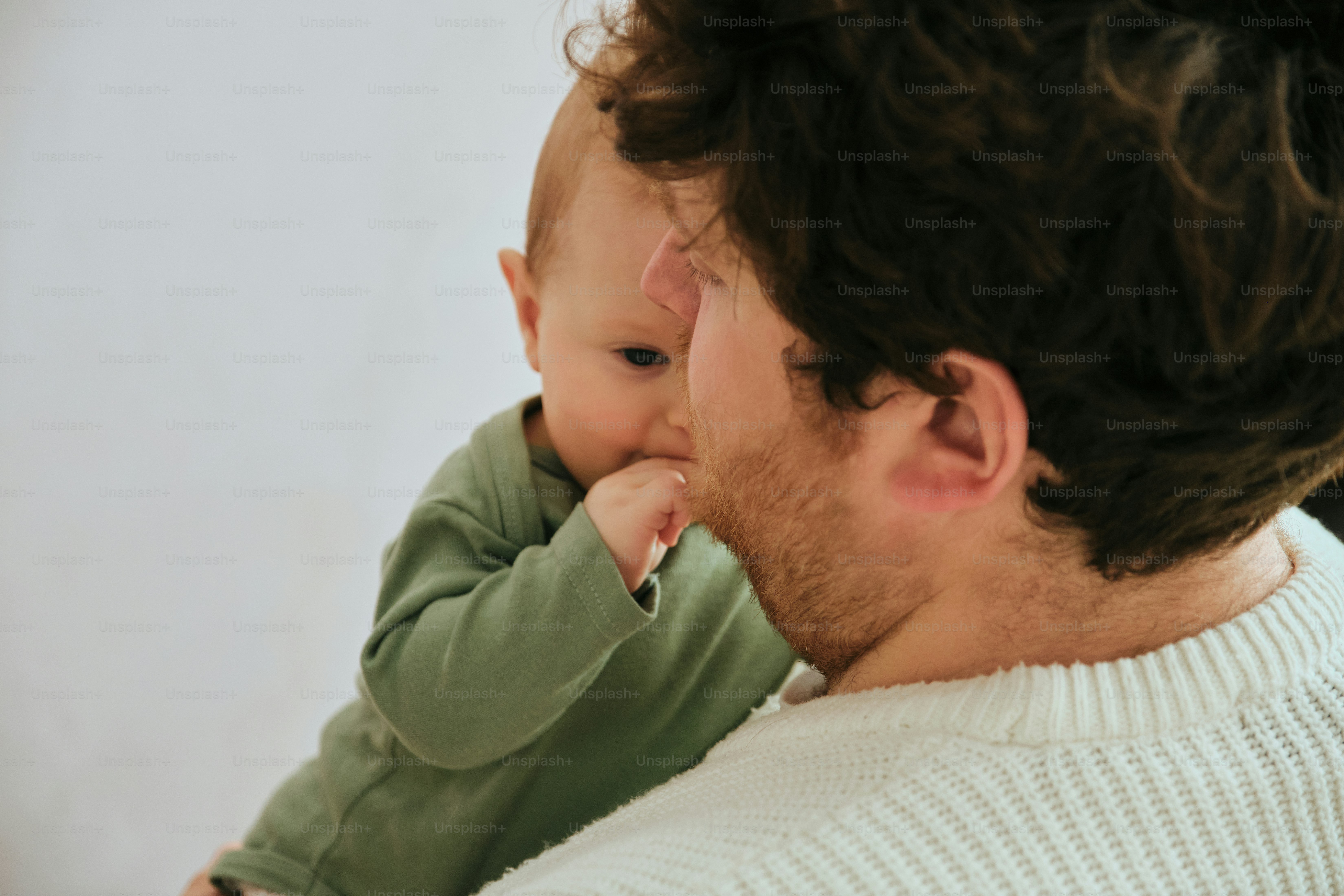 Father holding his baby close to his face