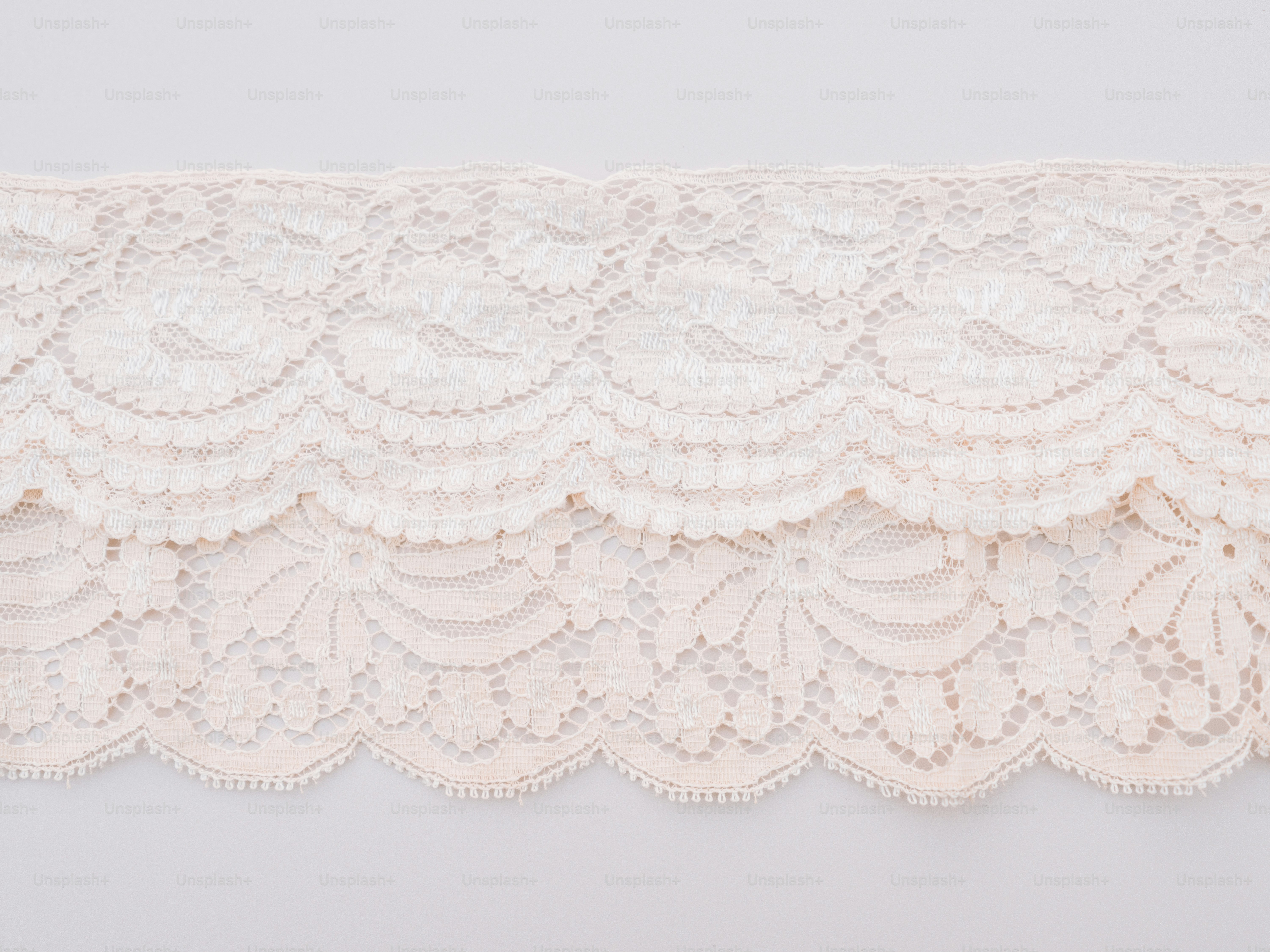 Delicate cream lace trim with scalloped edges