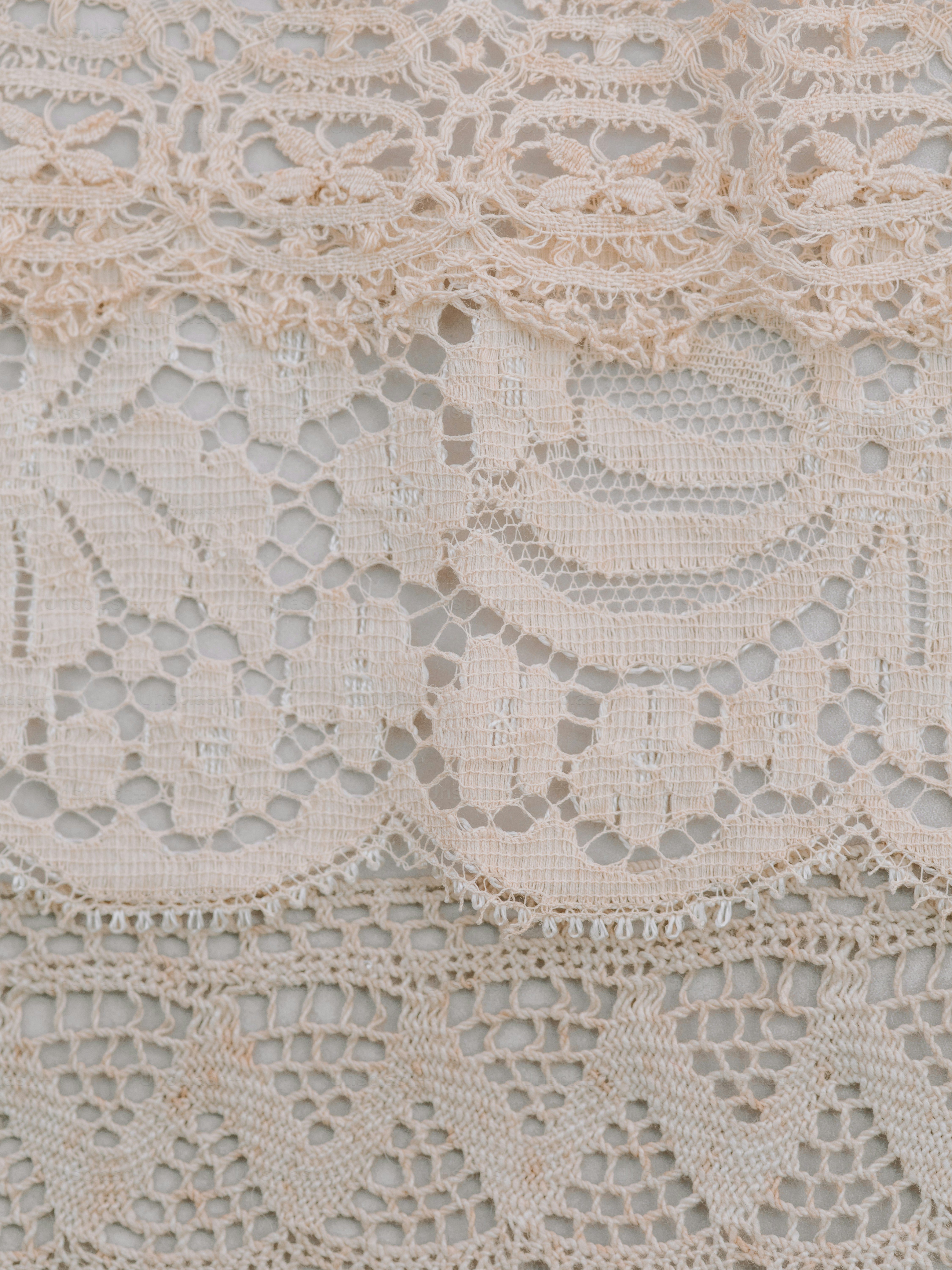 Close-up of layered cream lace trim details.