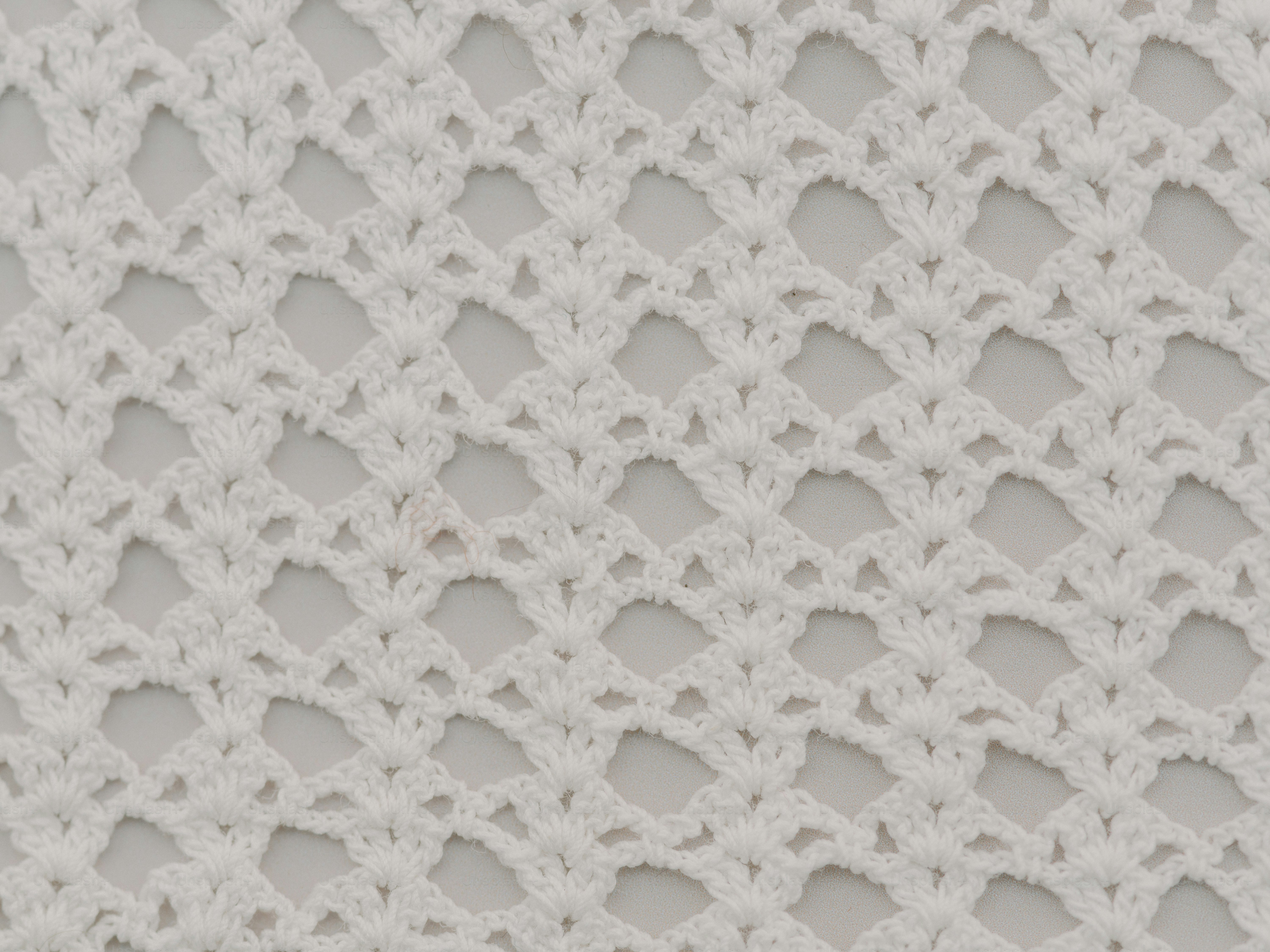 White crochet fabric with a delicate pattern