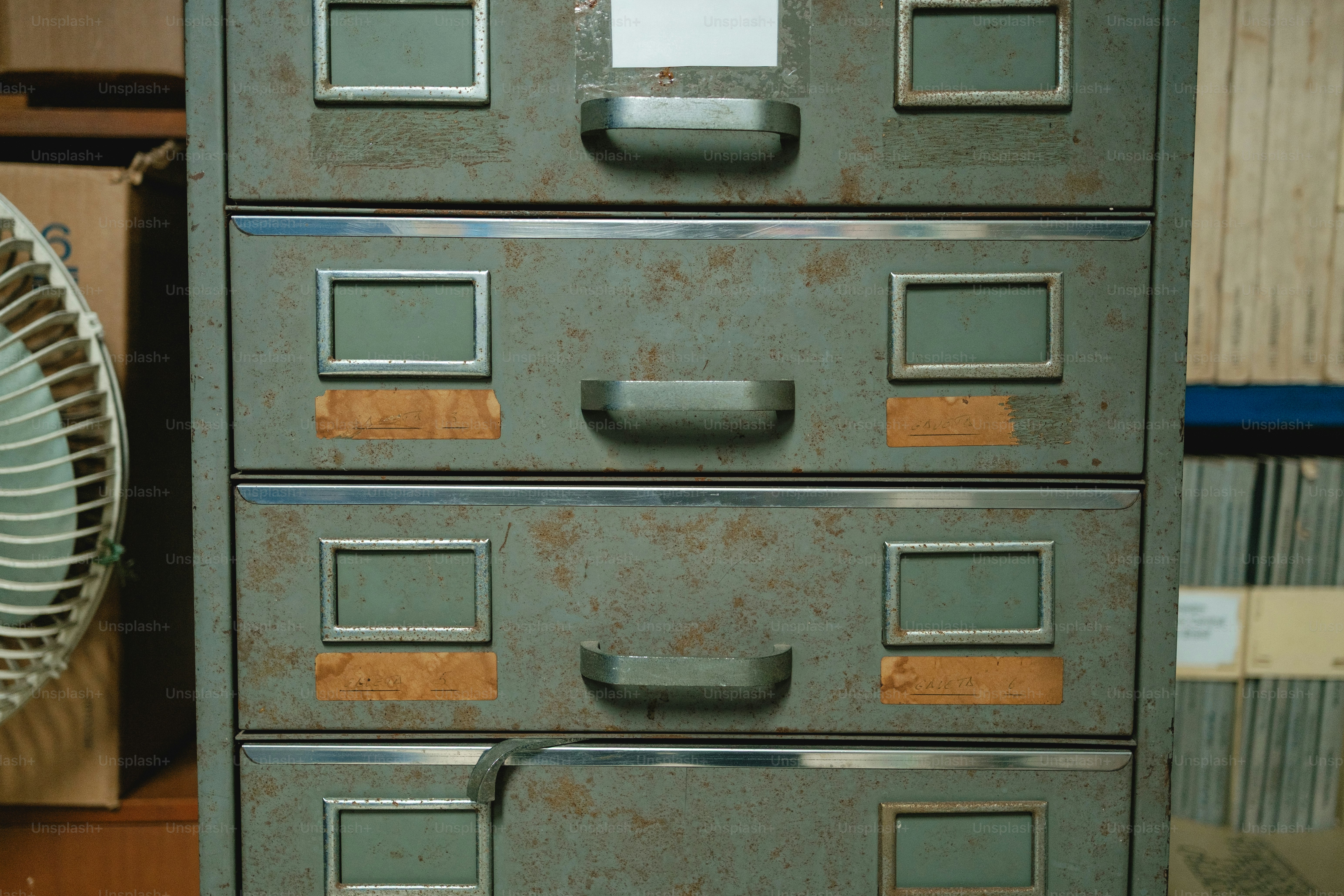 A vintage metal filing cabinet with four drawers
