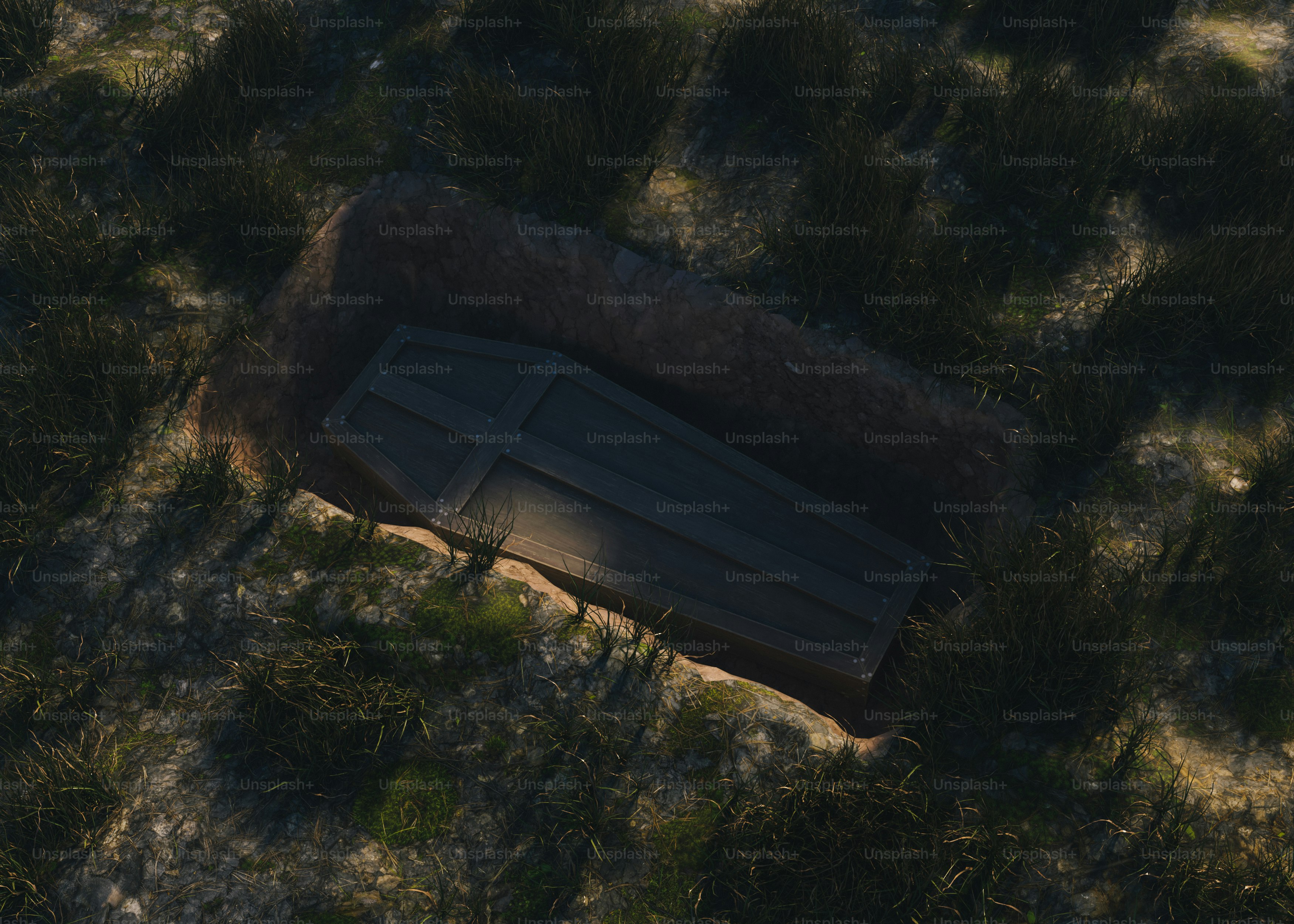 A coffin lies in an open grave.