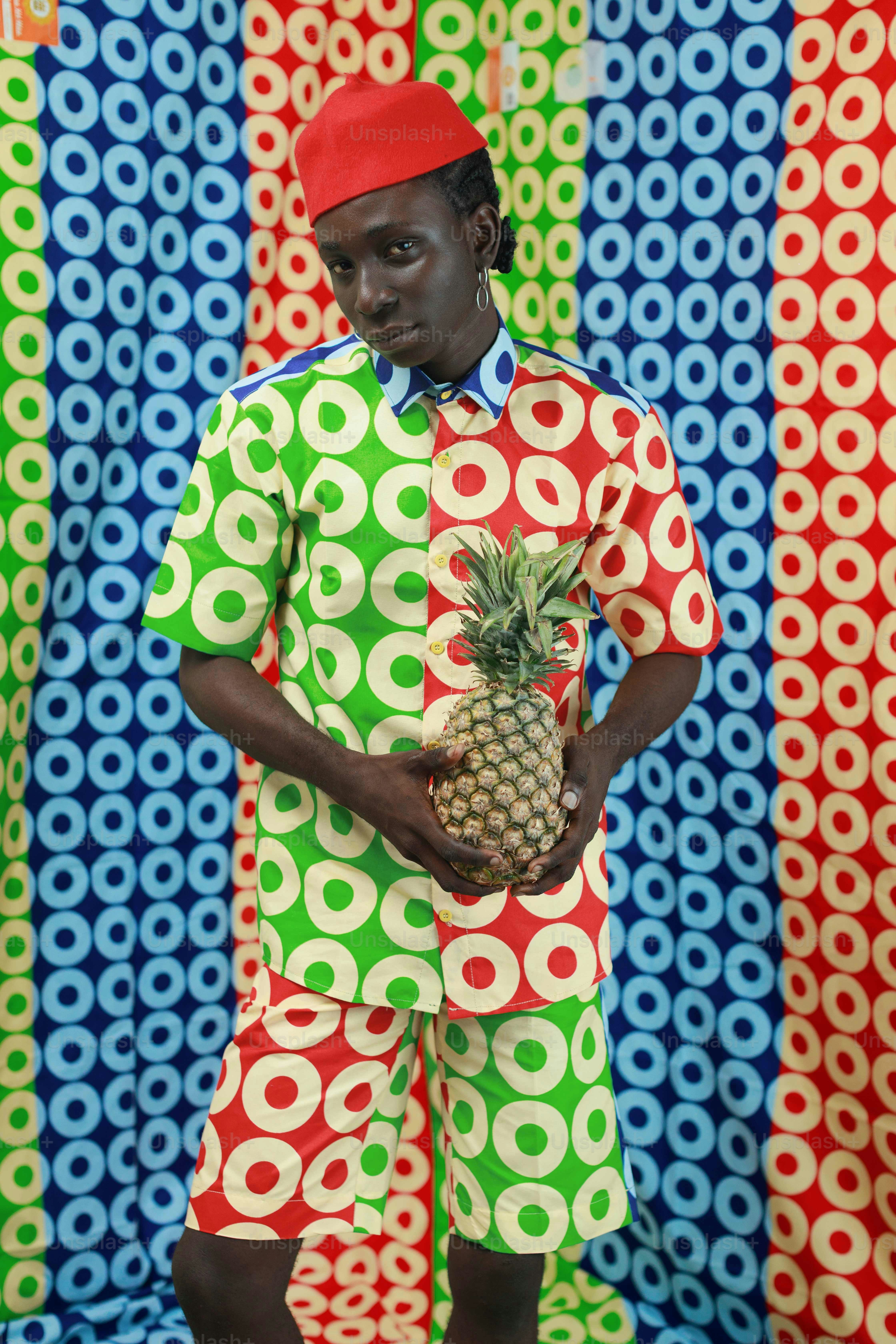 Woman in colorful patterned outfit against a patterned background photo ...