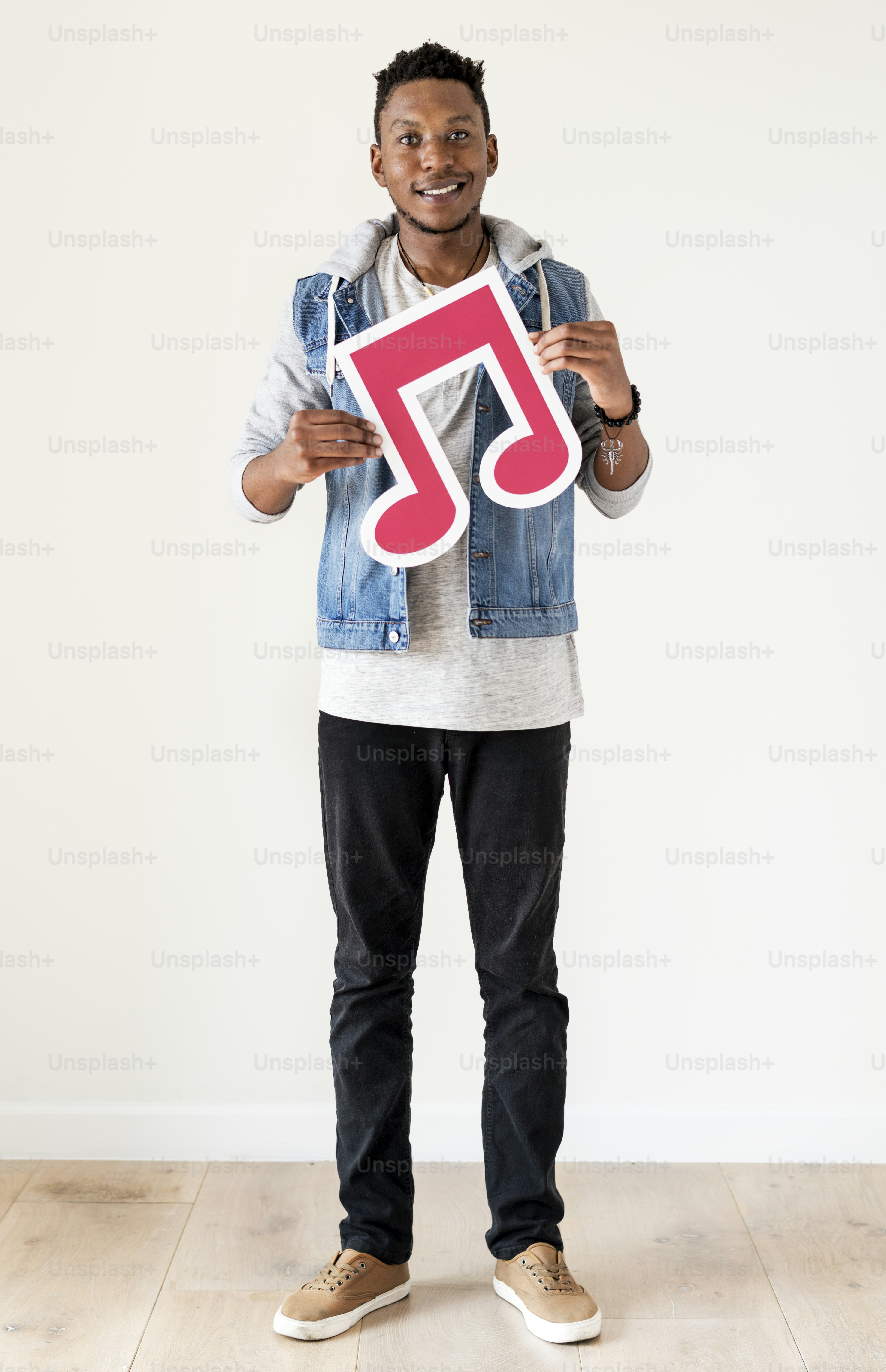 African descent man holding a musical note icon