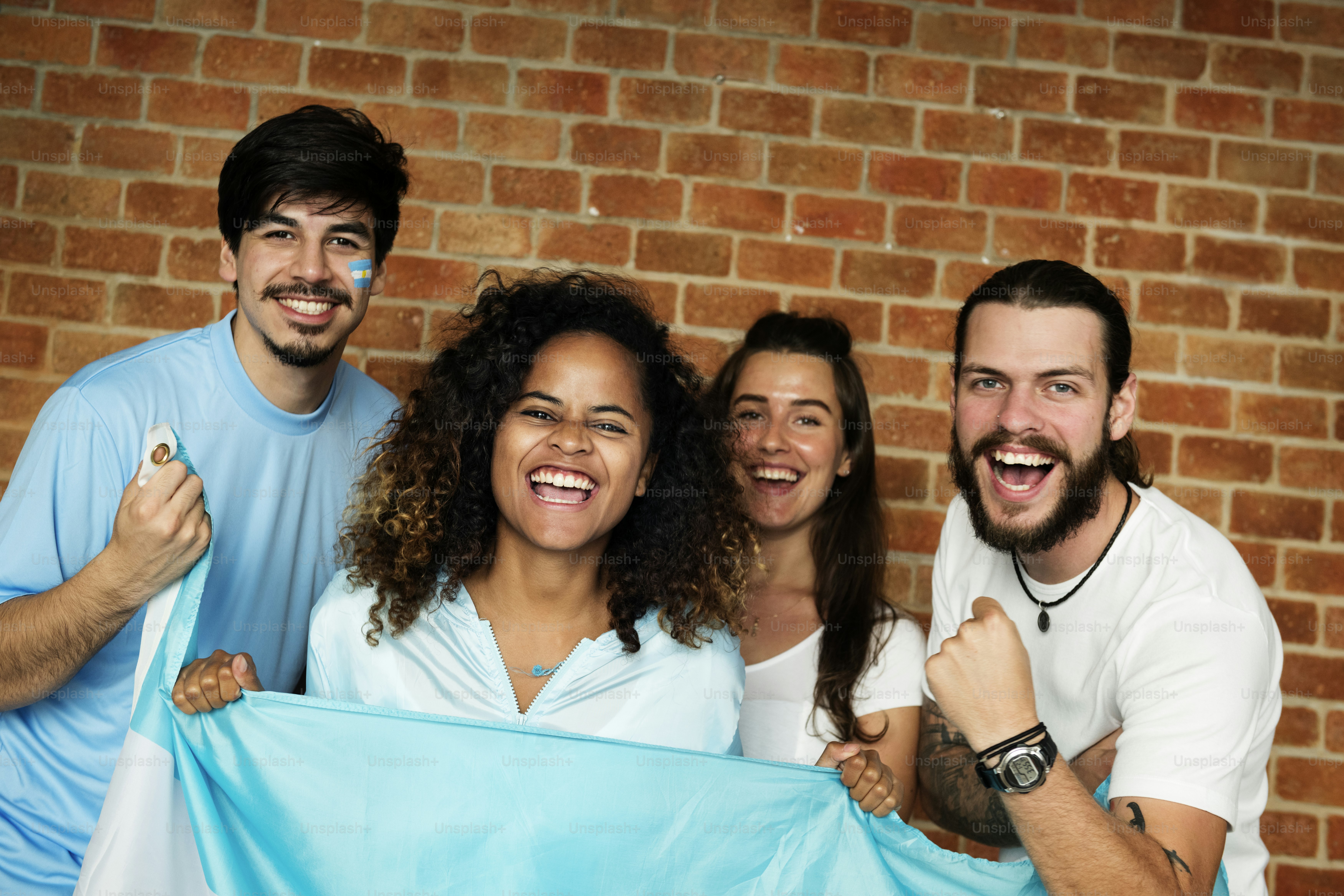 Friends cheering world cup with painted flag