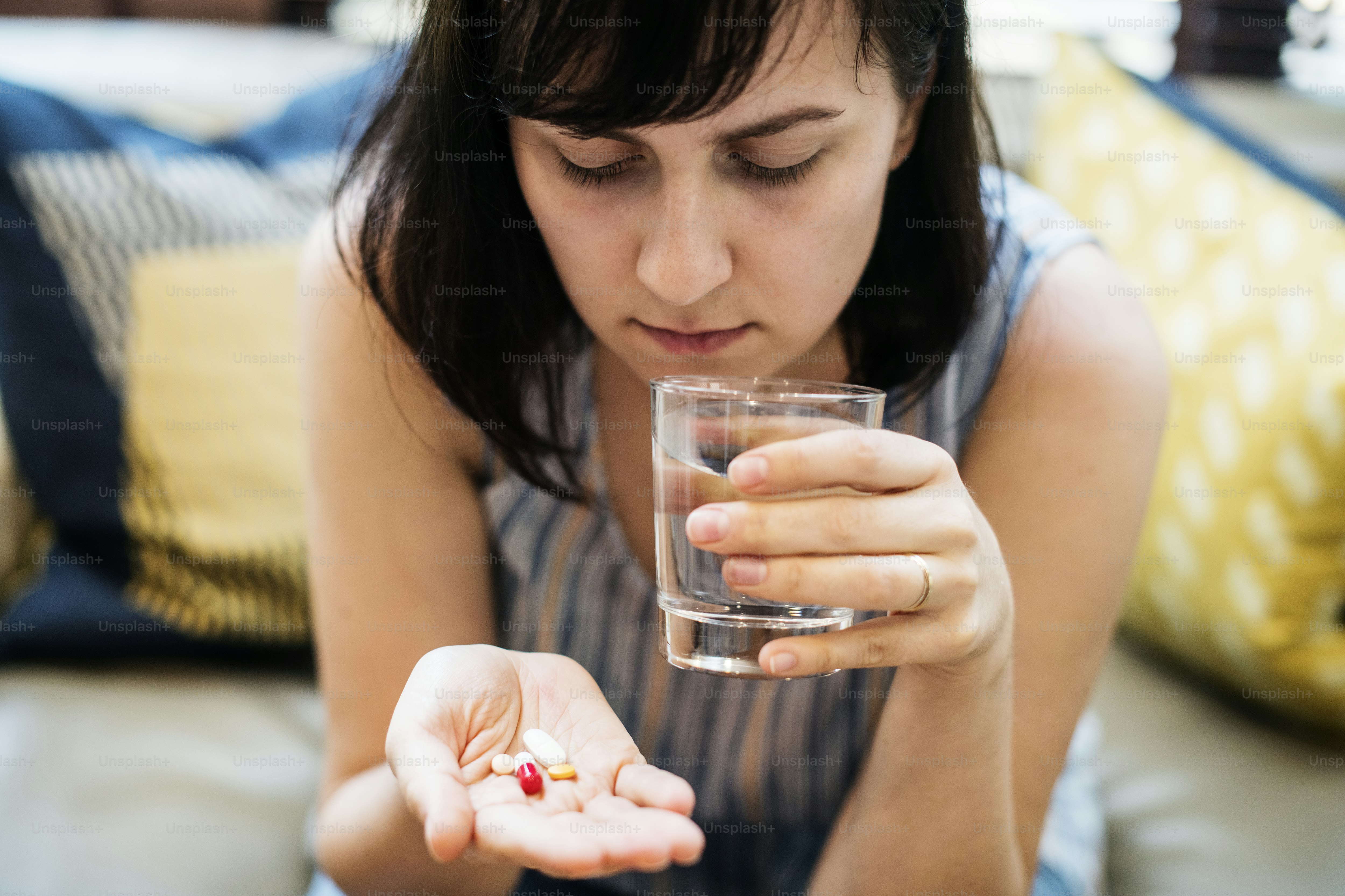 Woman taking medication for her illness