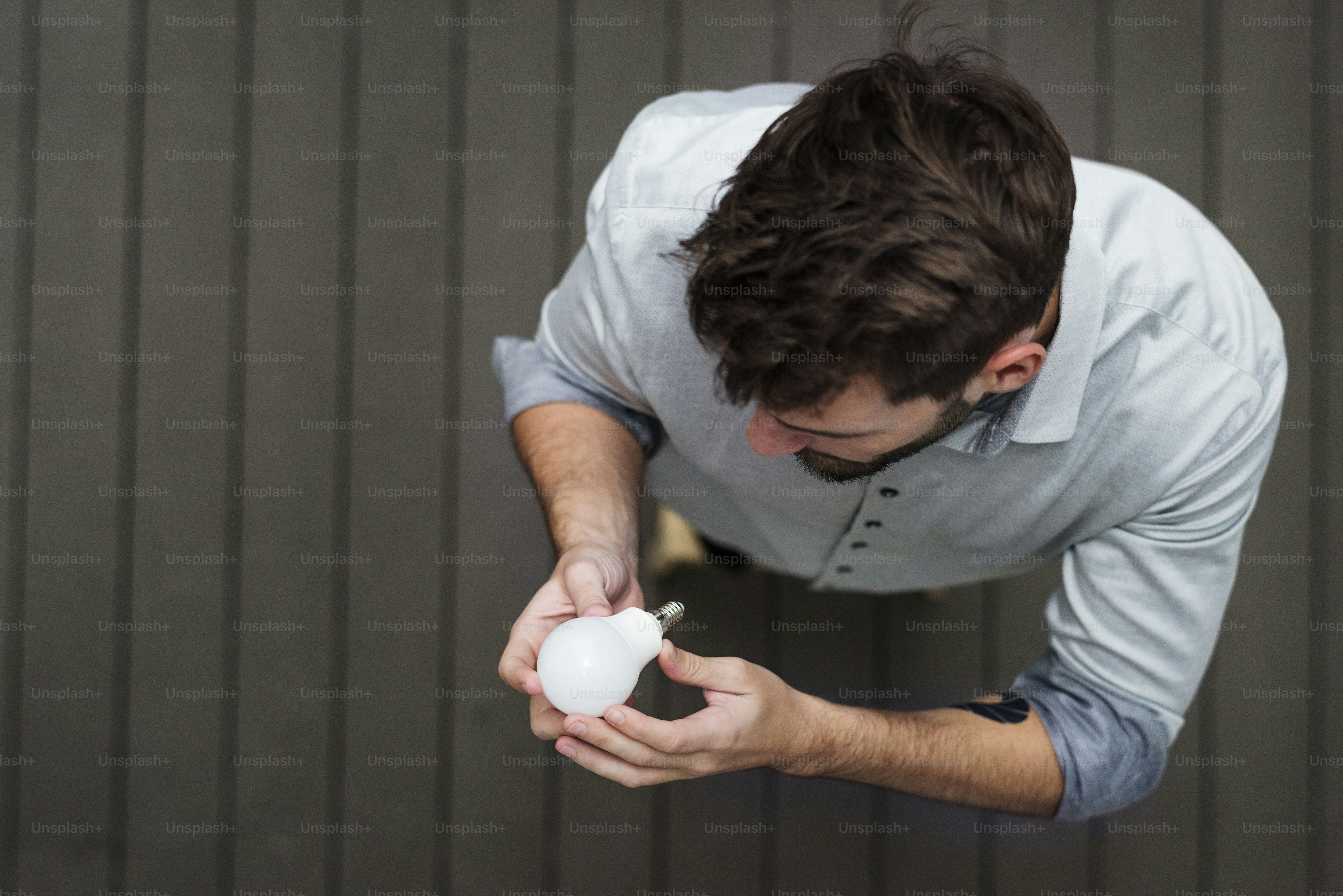 A man changing a light bulb
