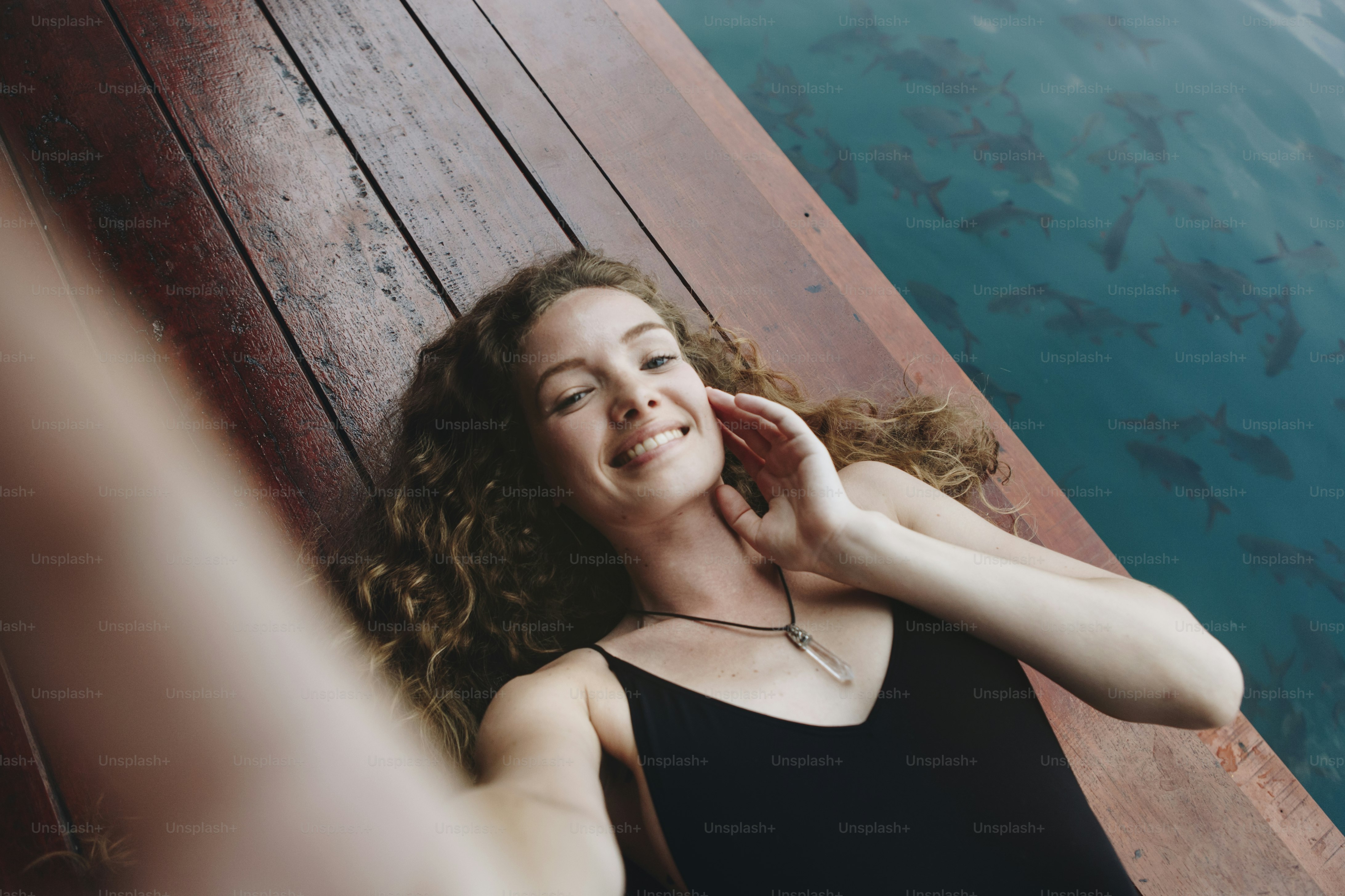 Woman relaxing on a wooden jetty