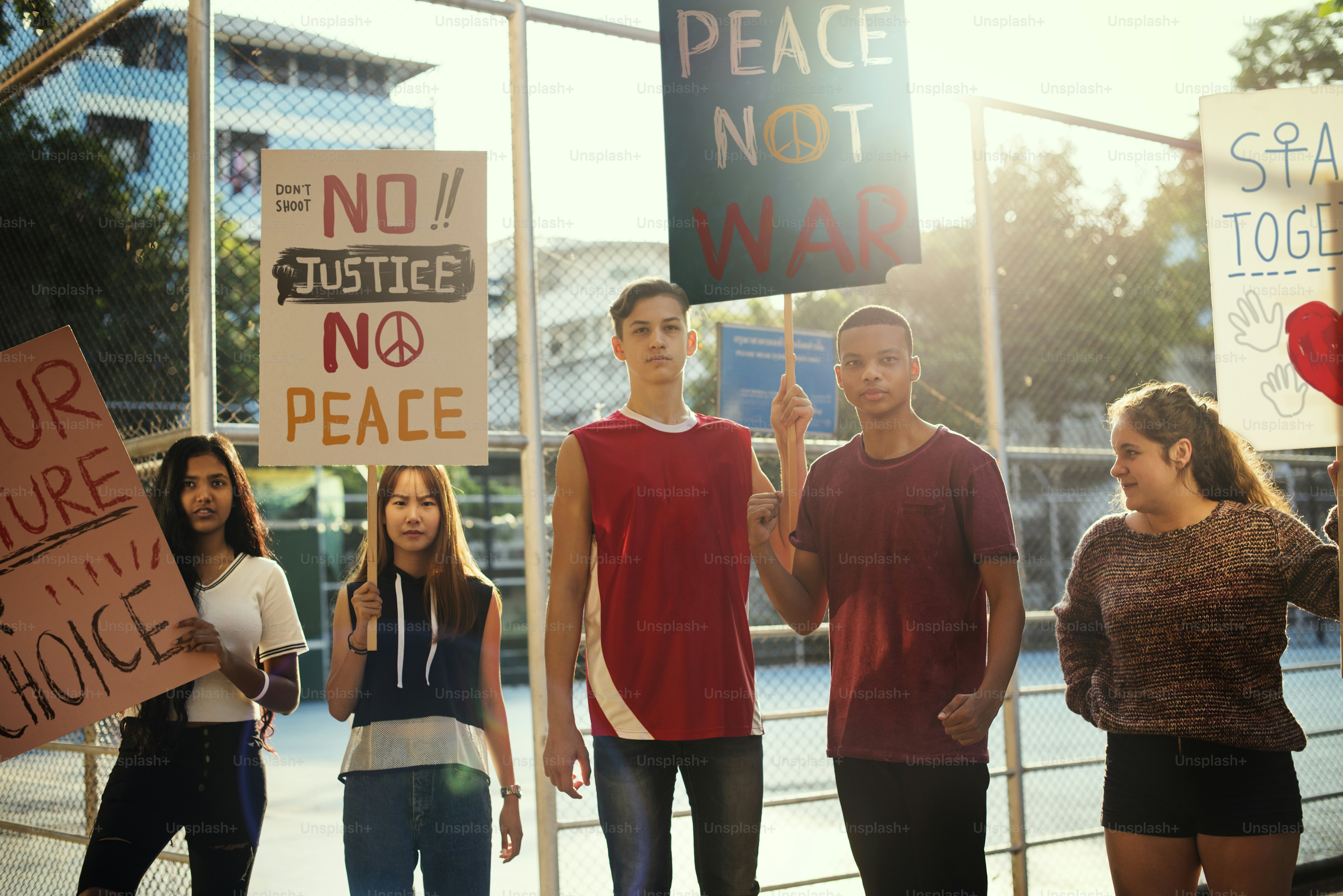 Group of teenagers protesting demonstration holding posters antiwar justice peace concept***These graphics are derived from our own 3D generic models. They do not infringe on any copyright design.***