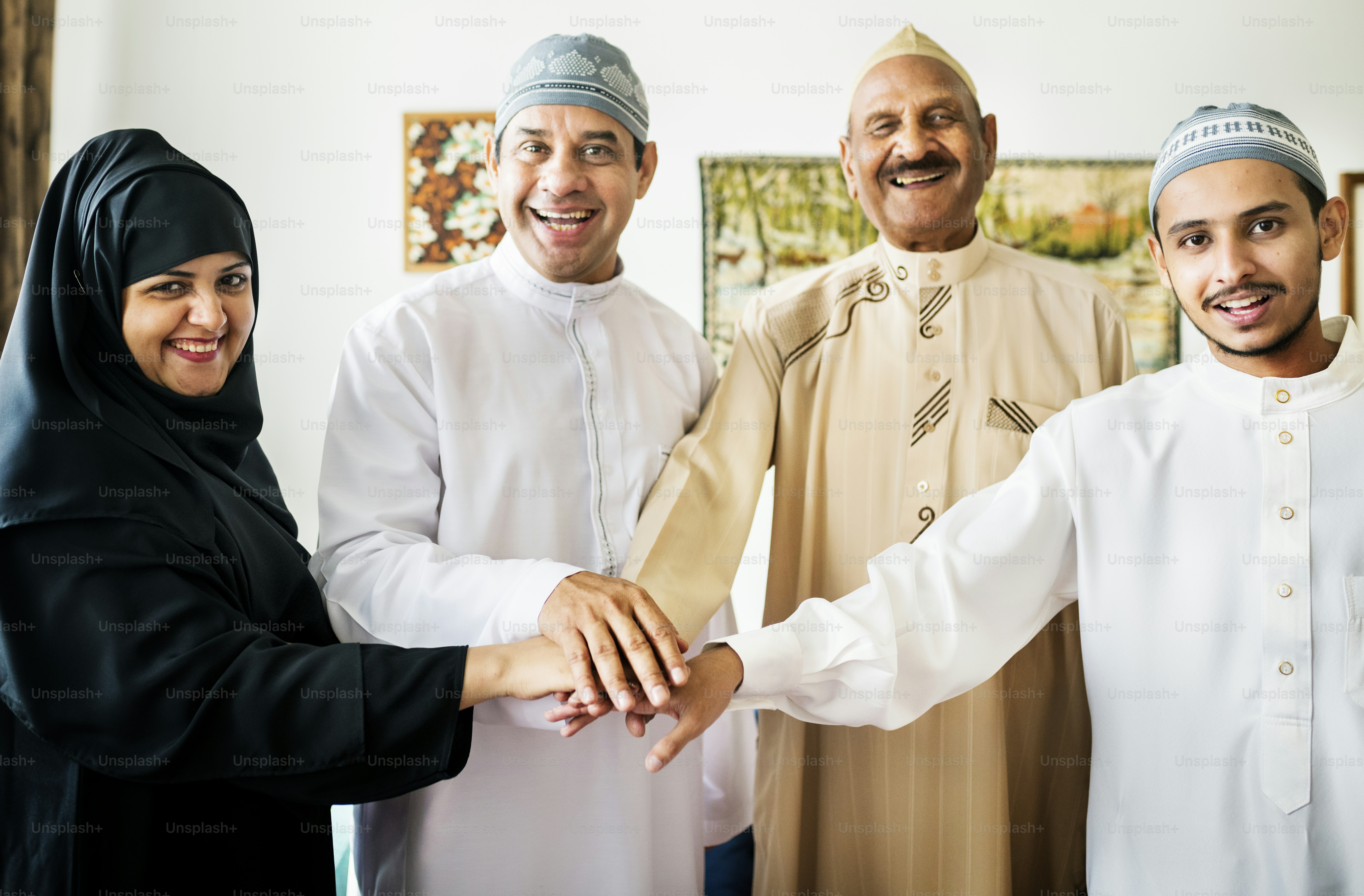 Happy family joining hands portraying teamwork and unity concept**Documentation proving the source is available in the public domain***