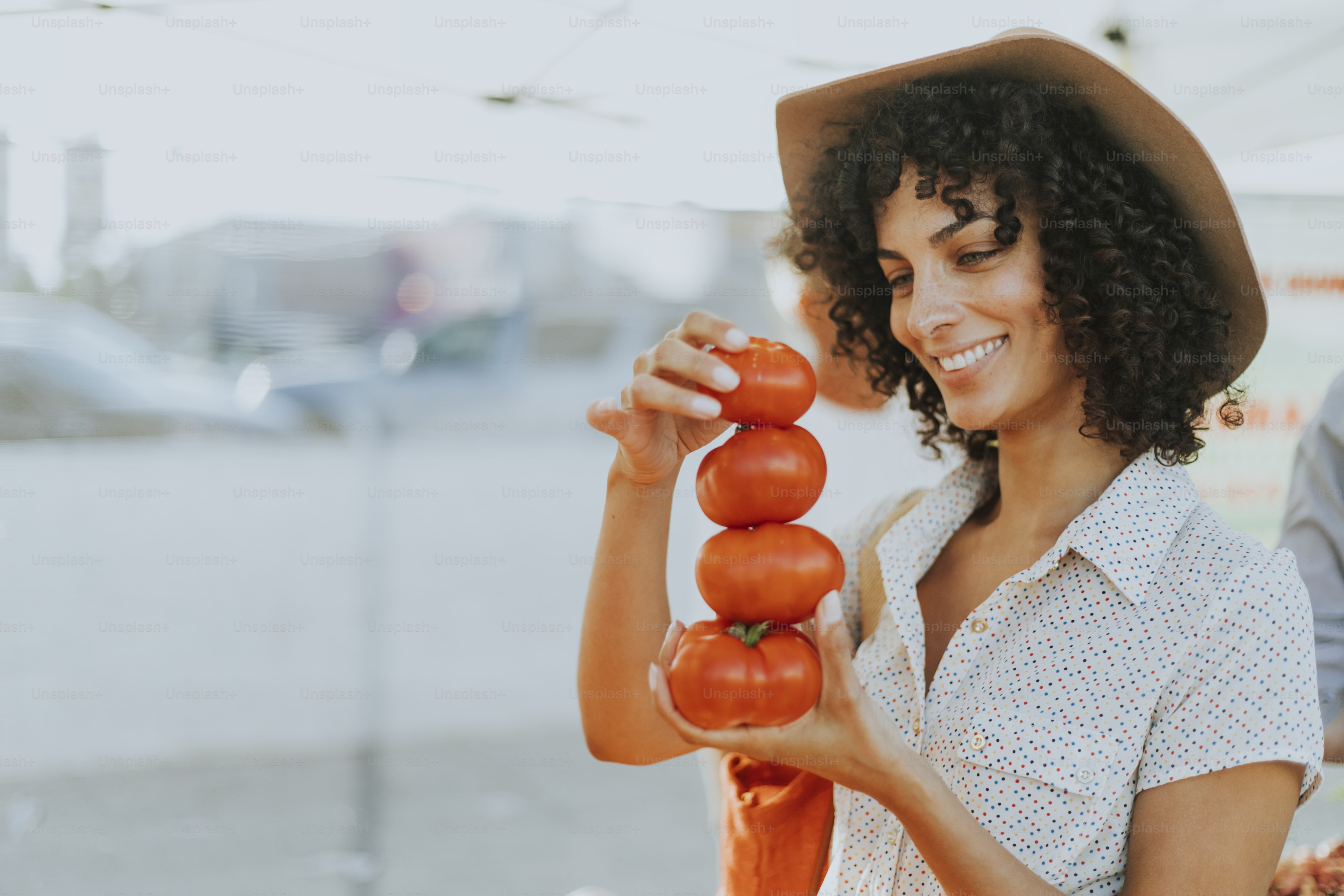 Woman buying tomatoes at a farmers market