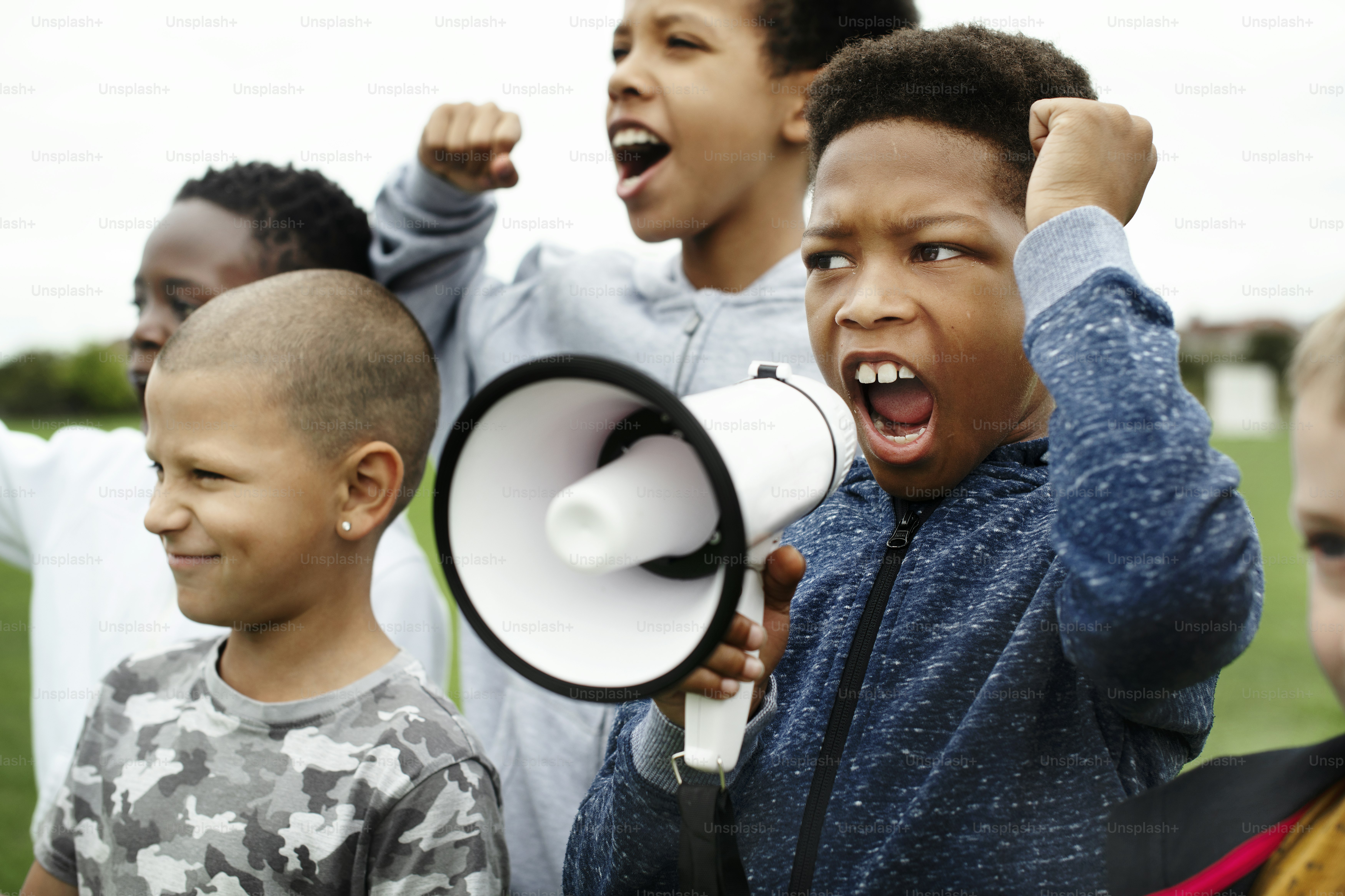 Young boy shouting on a megaphone in a protest