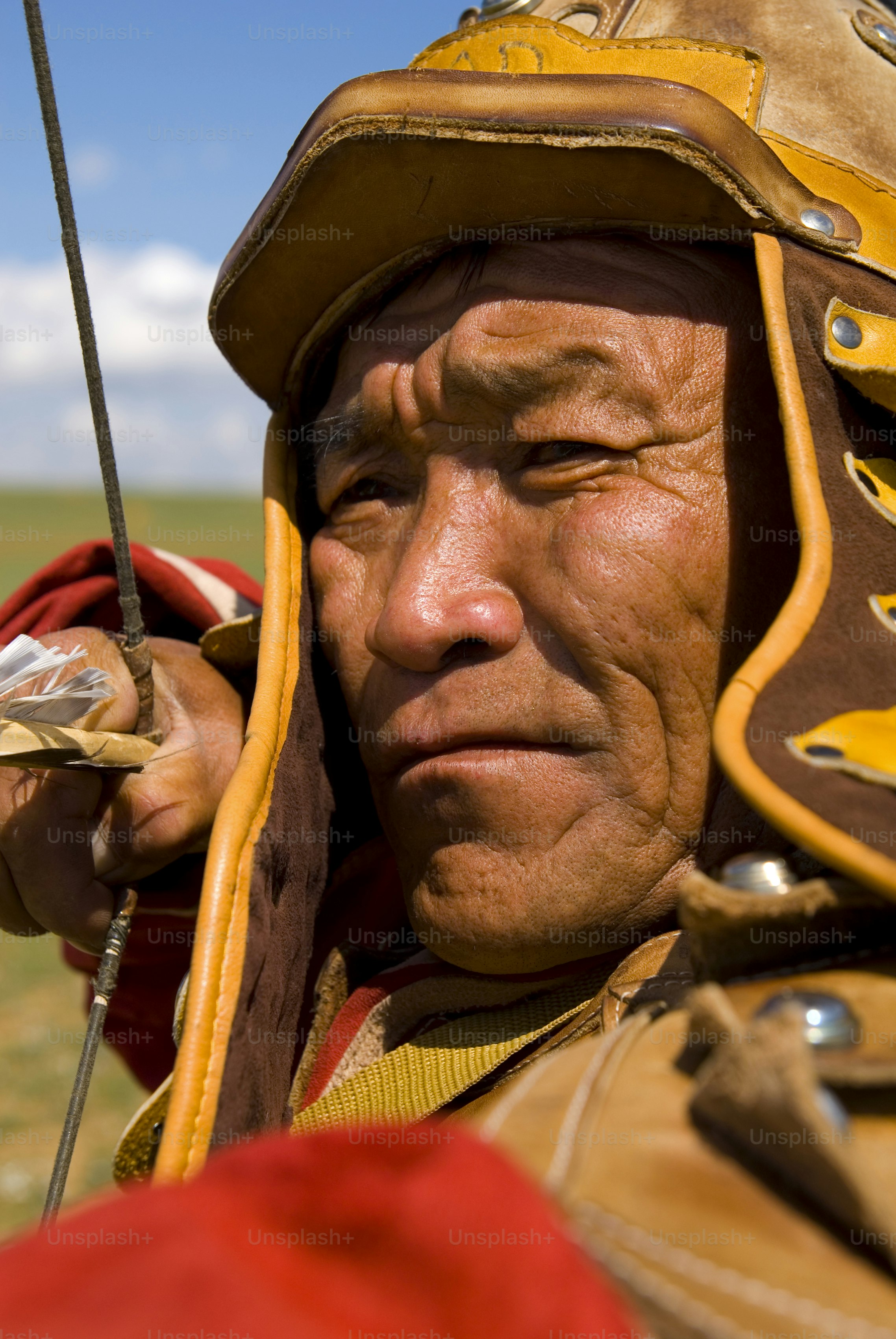 Man in traditional mongolian warrior attire with bow