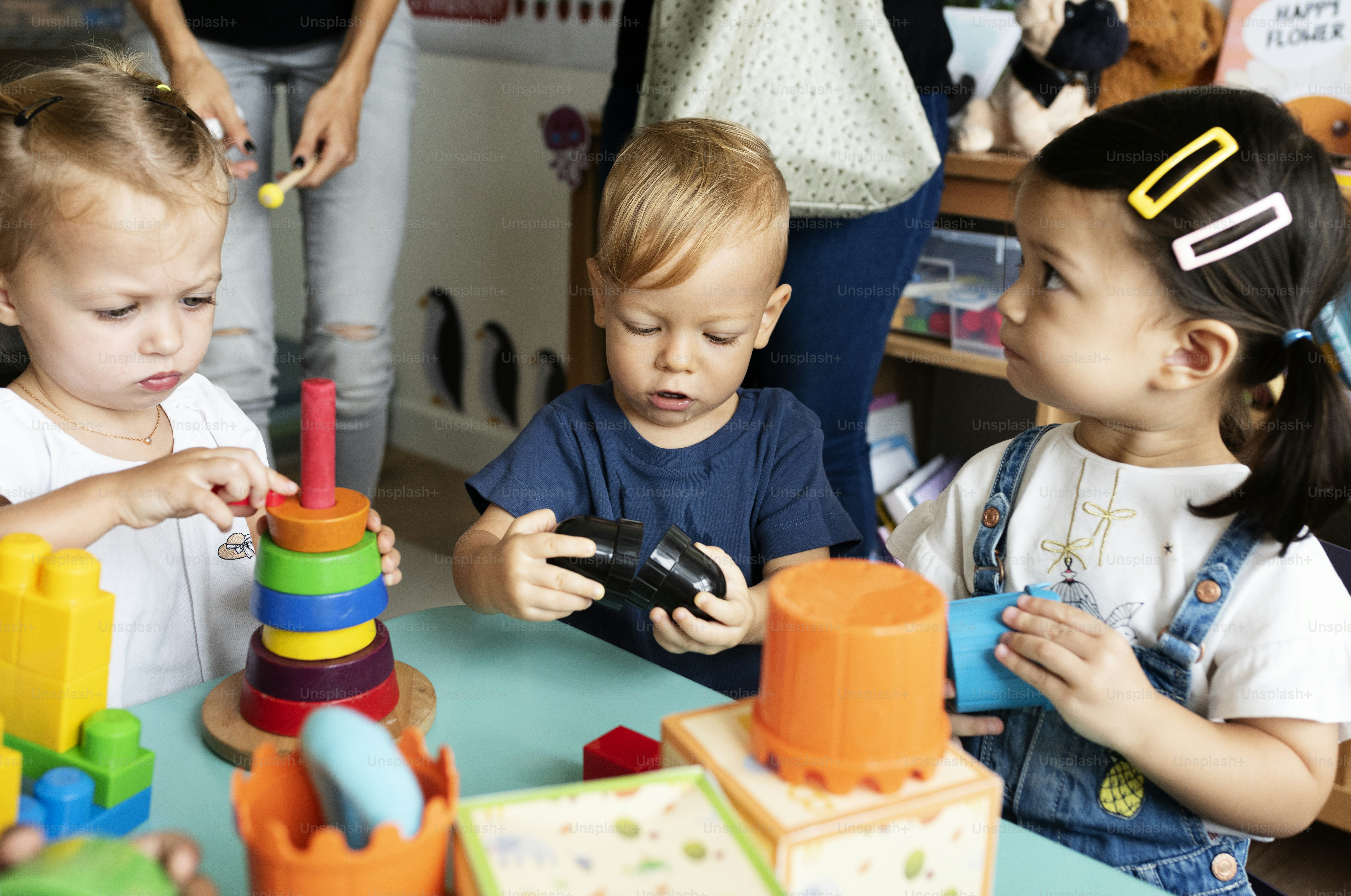 Nursery children playing with teacher in the classroom photo ...