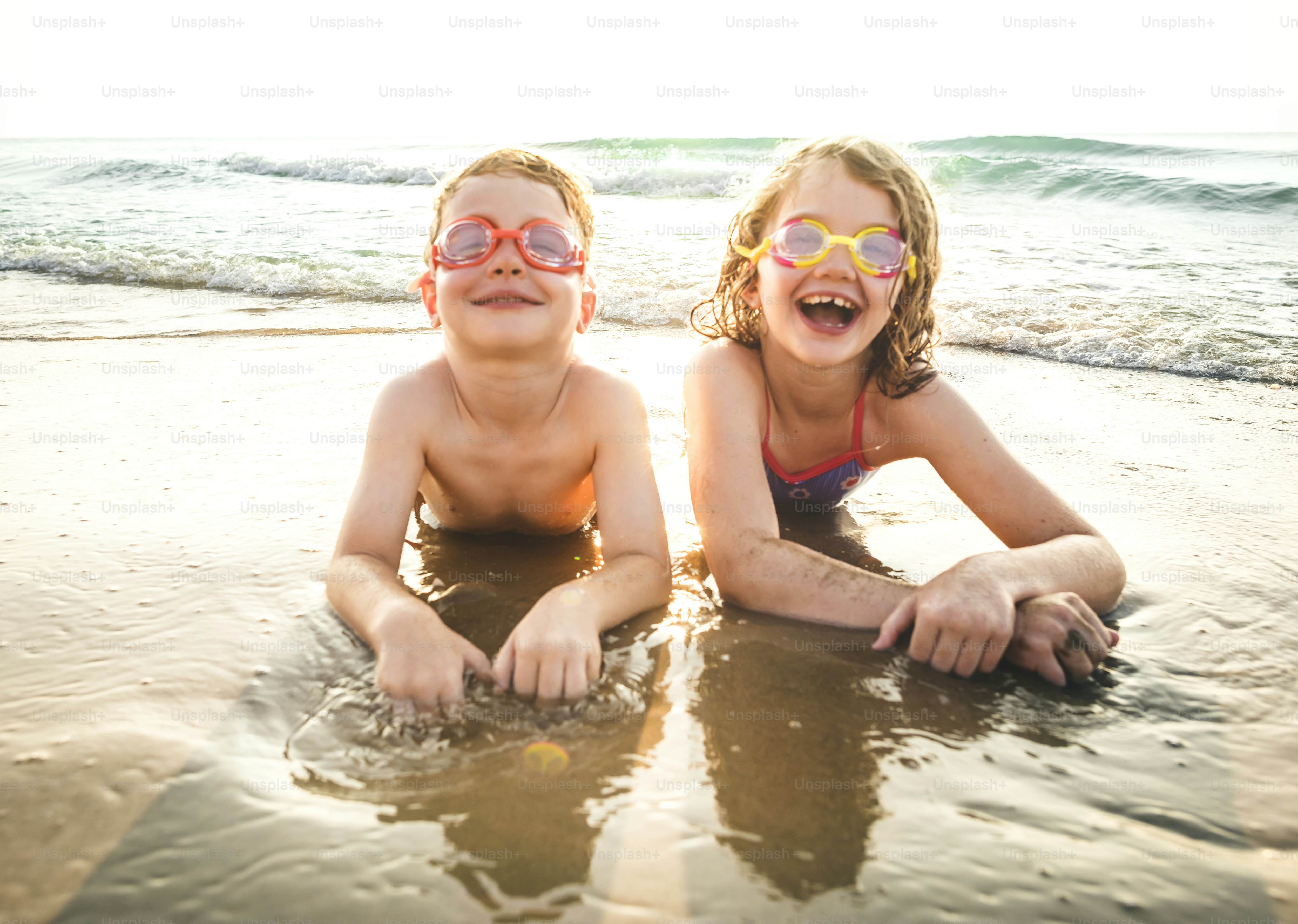 Little brother and sister having fun on the beach photo – Beach Image ...
