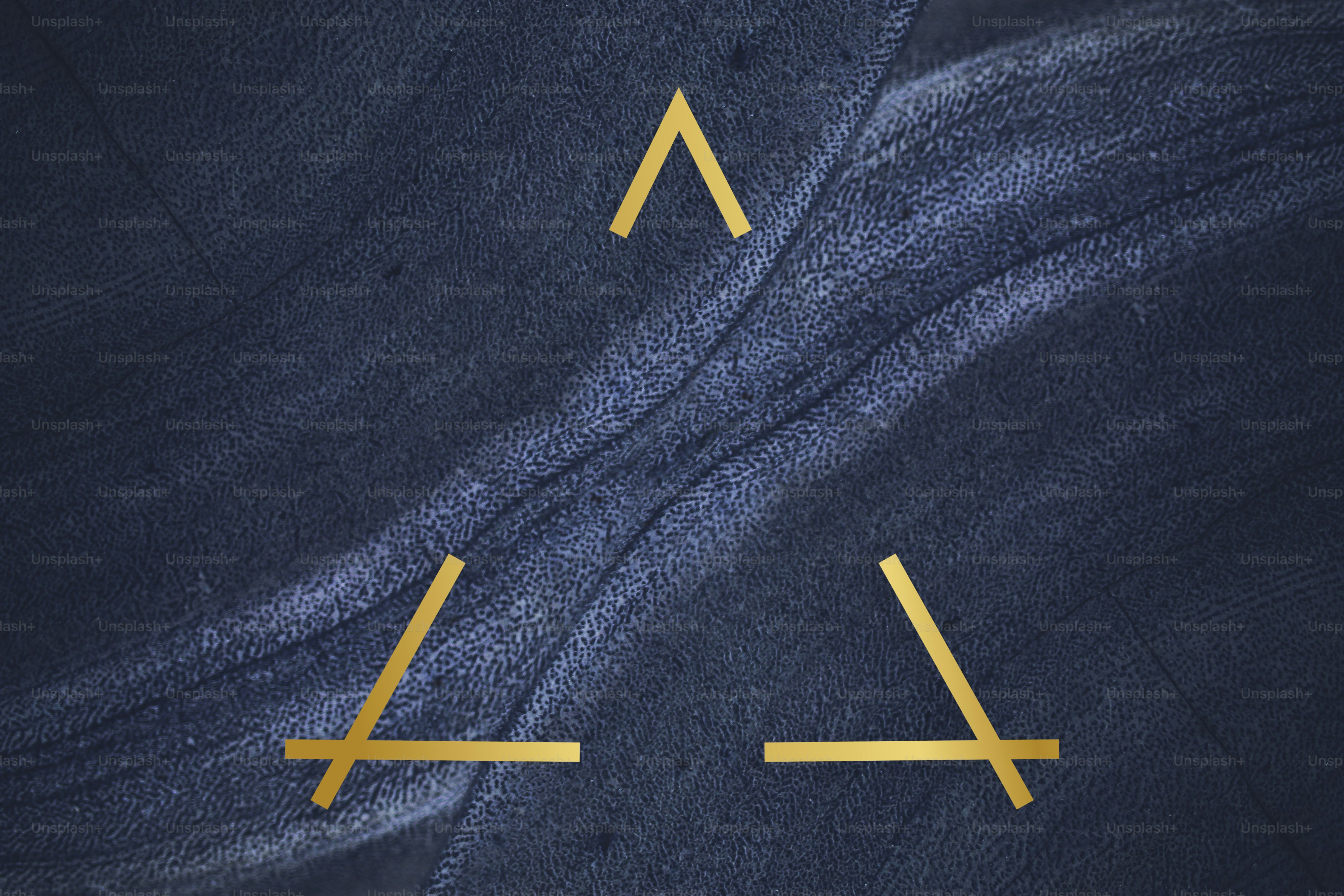 Golden framed triangle on a blue textured stone