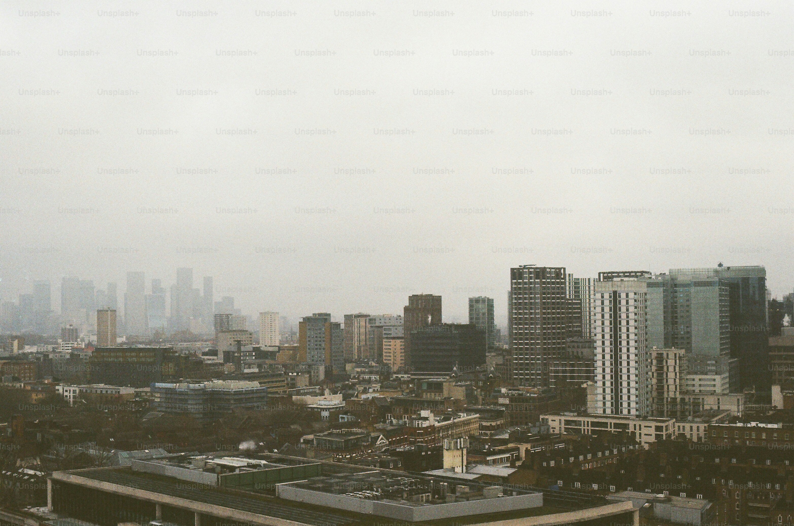 City skyline with tall buildings under a hazy sky photo – Architecture ...