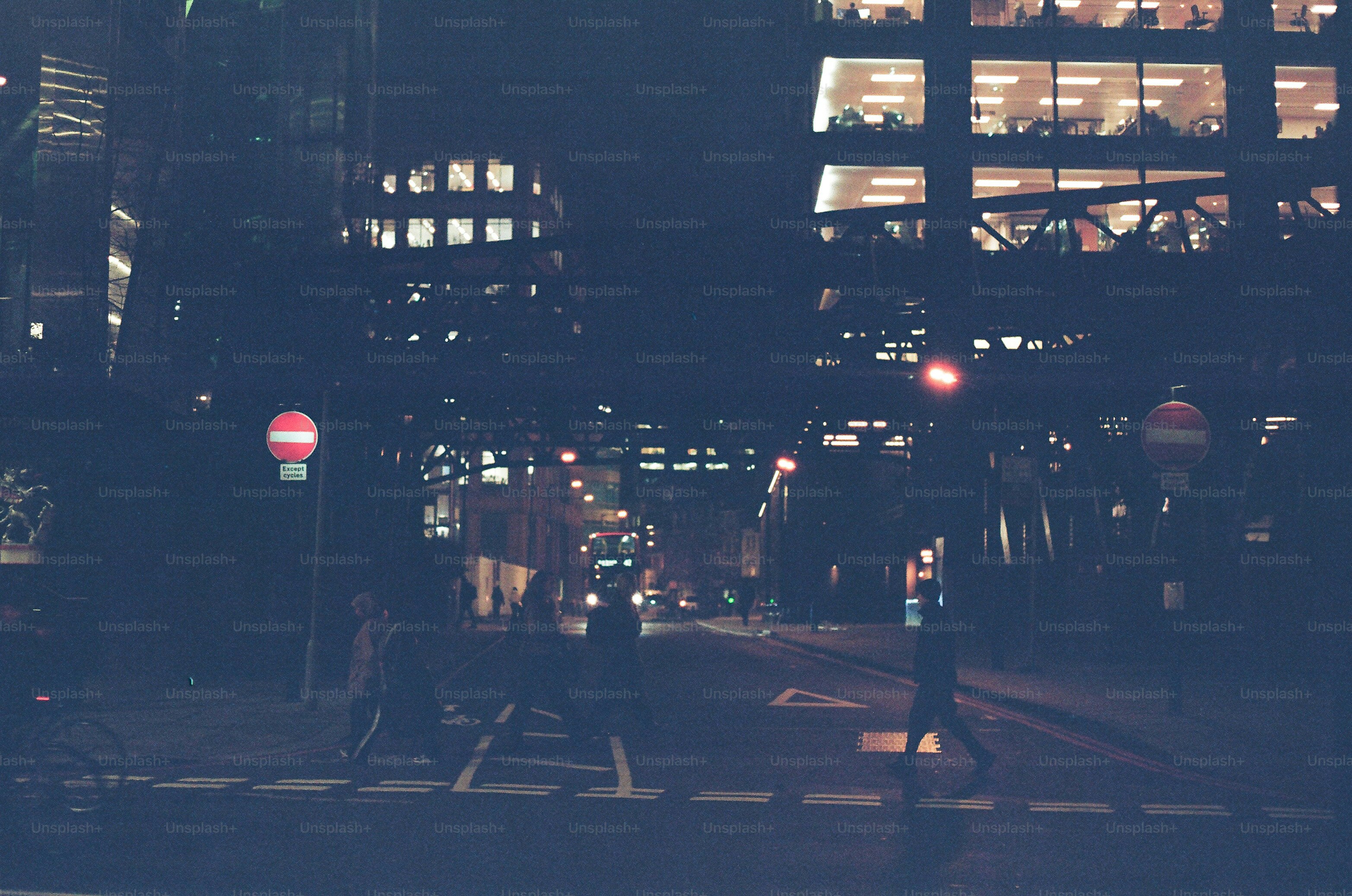City street at night with illuminated buildings and pedestrians. photo ...