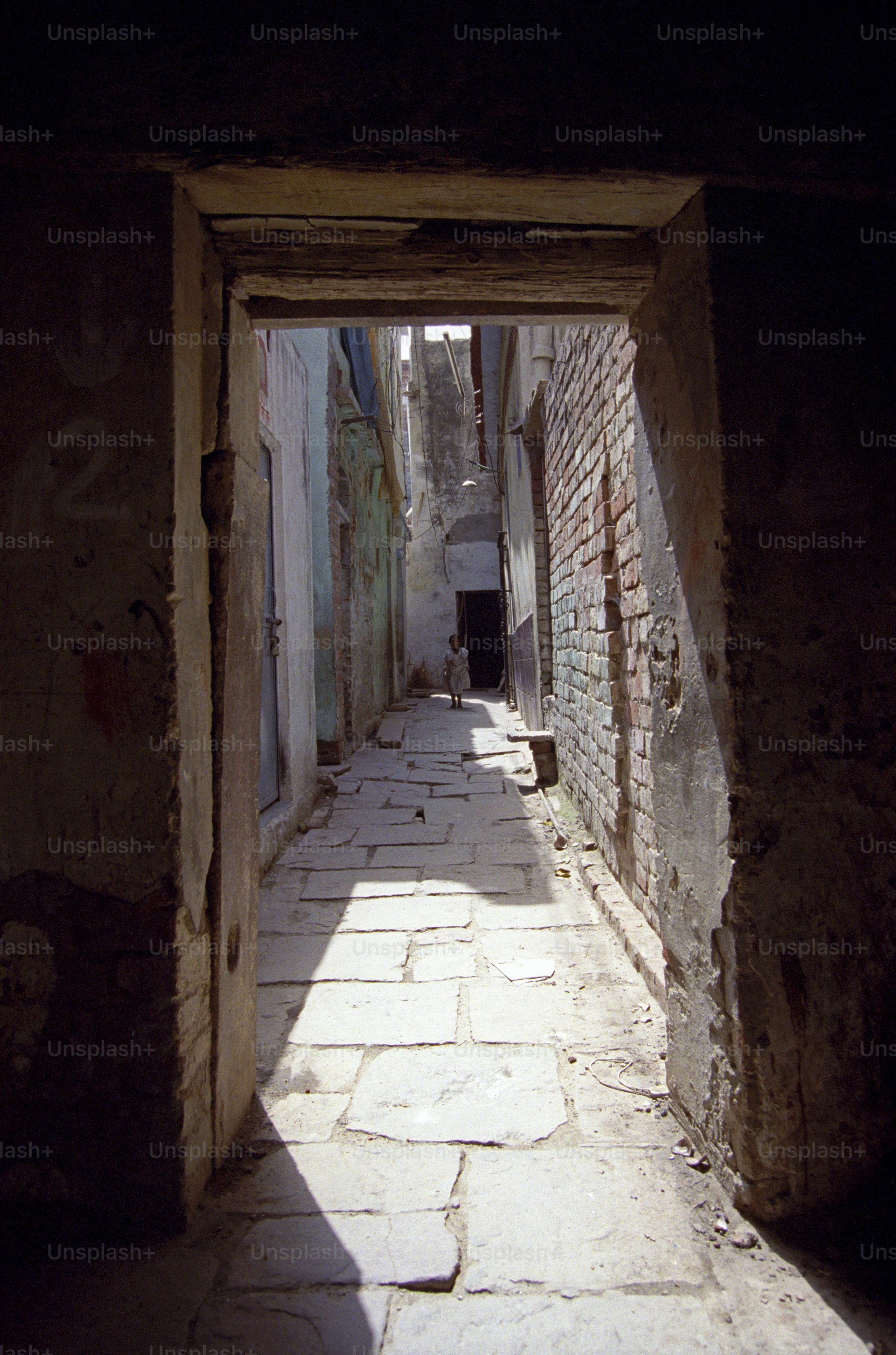 A young Indian girl is skipping at the end of the alley. Delhi,India. Please see more Indian travel photos.