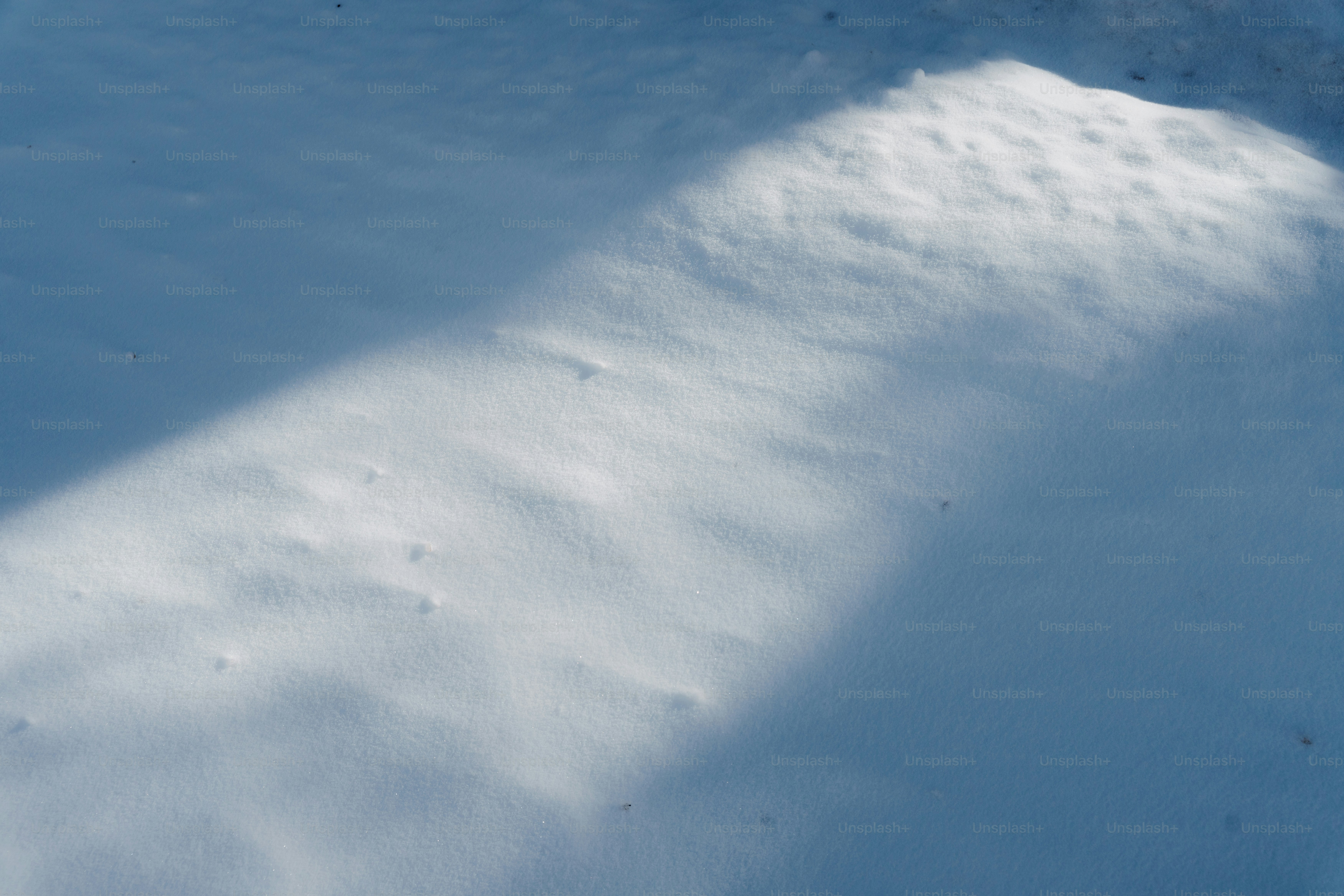 Sunlight casting a shadow on snow