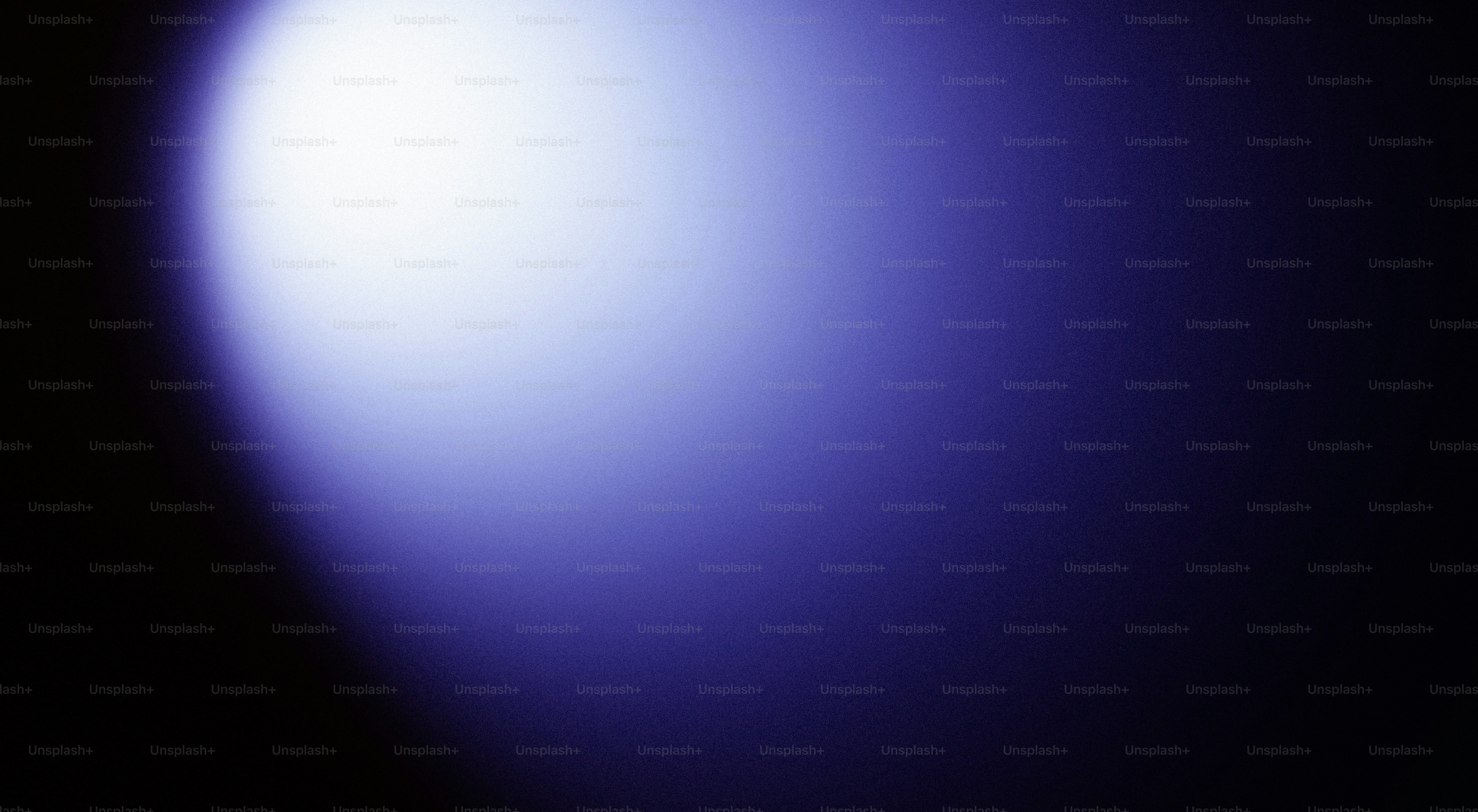 A bright white light fades into a dark blue background.