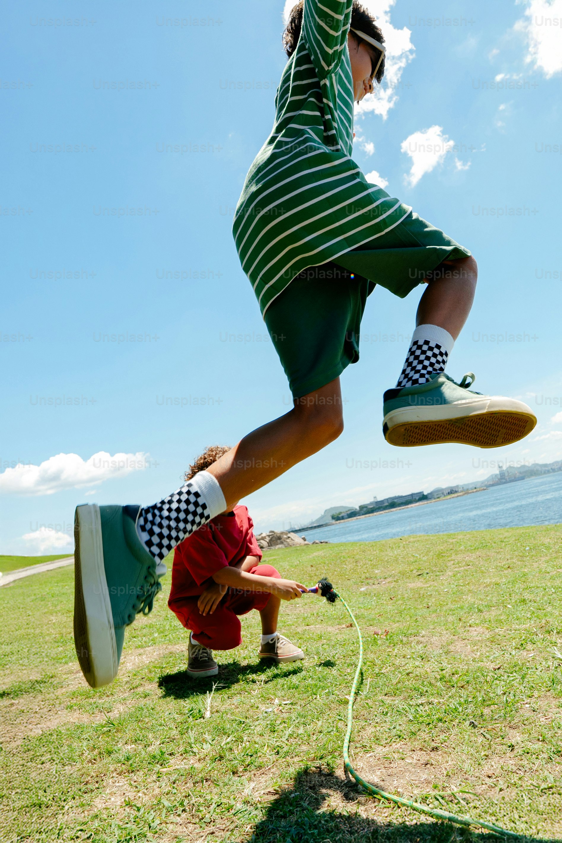 Children jumping rope on a sunny day outdoors
