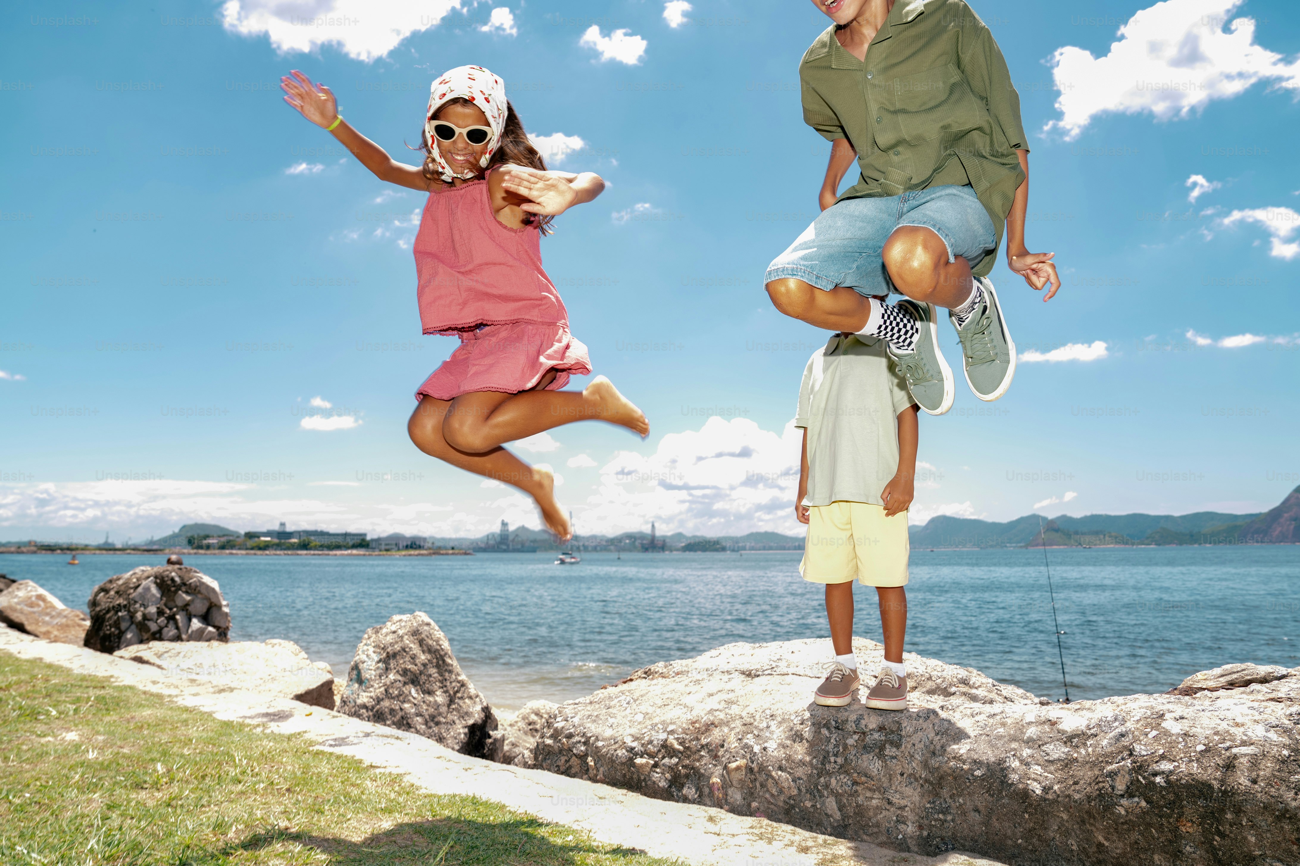 Children jumping with joy by the sea
