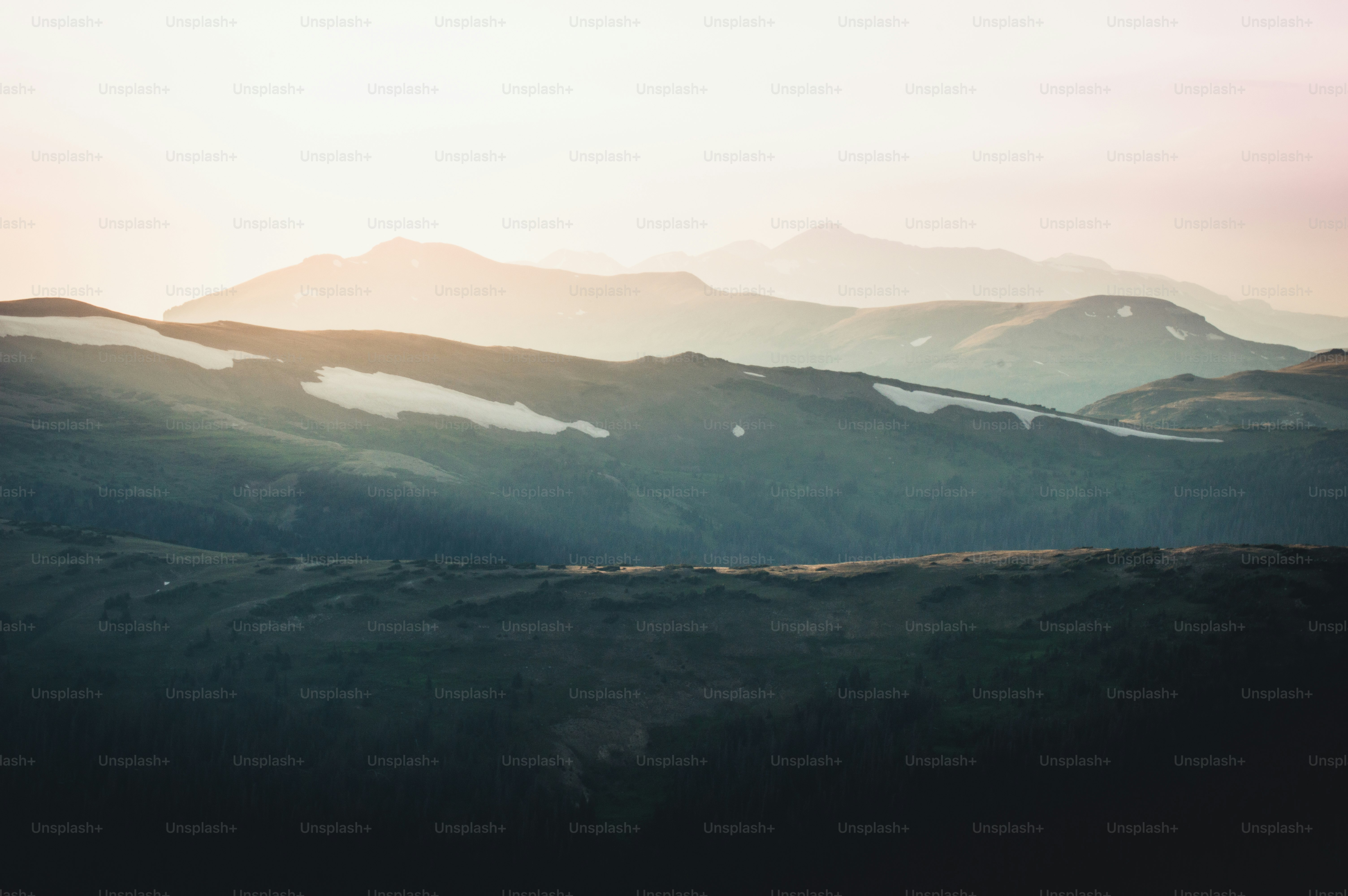Layered mountain ranges fade into a hazy sky.