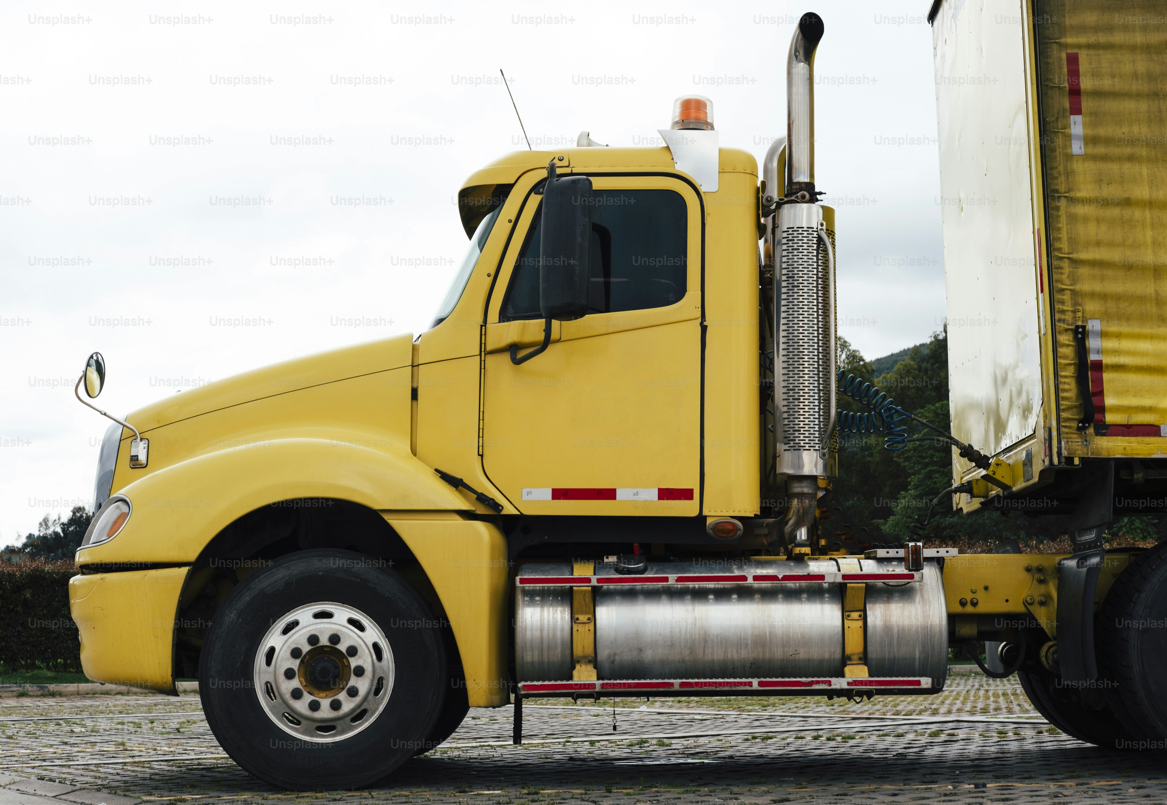 노란색 대형 트럭이 포장된 도로에 주차되어 있다